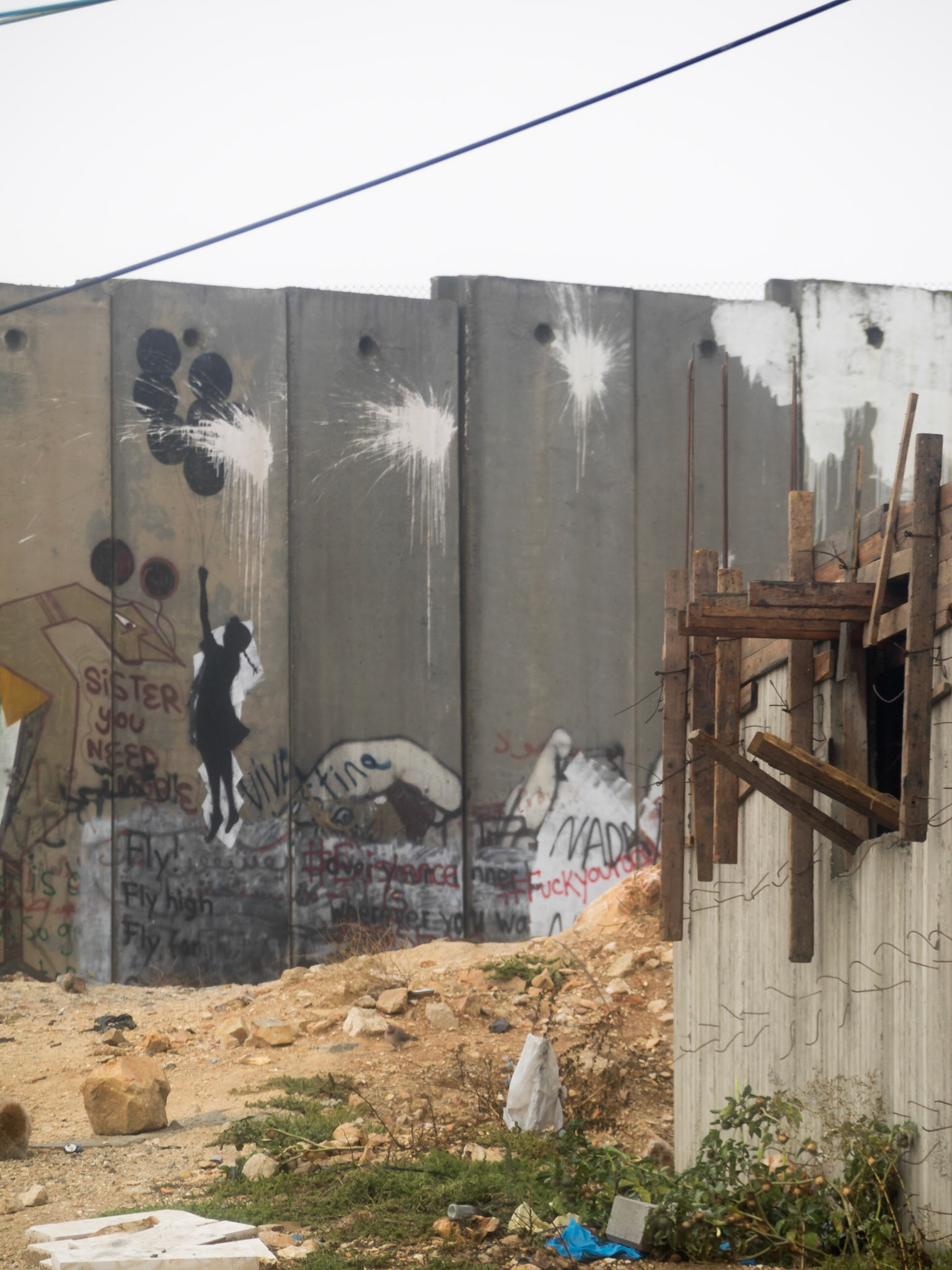 Banksy Girl with balloons graffiti painted on Ramallah city wall