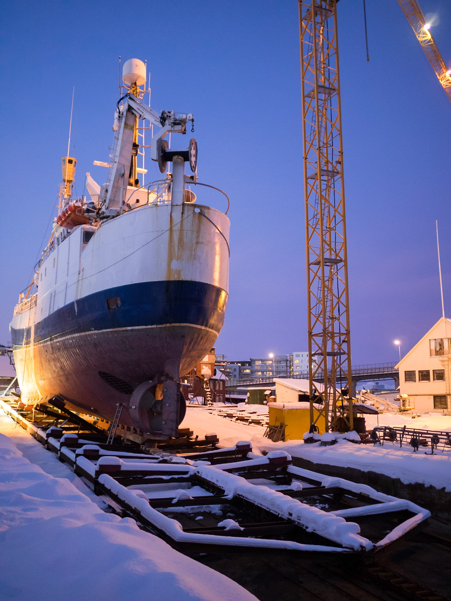 Big boat out of the water in the snow at Tromso port