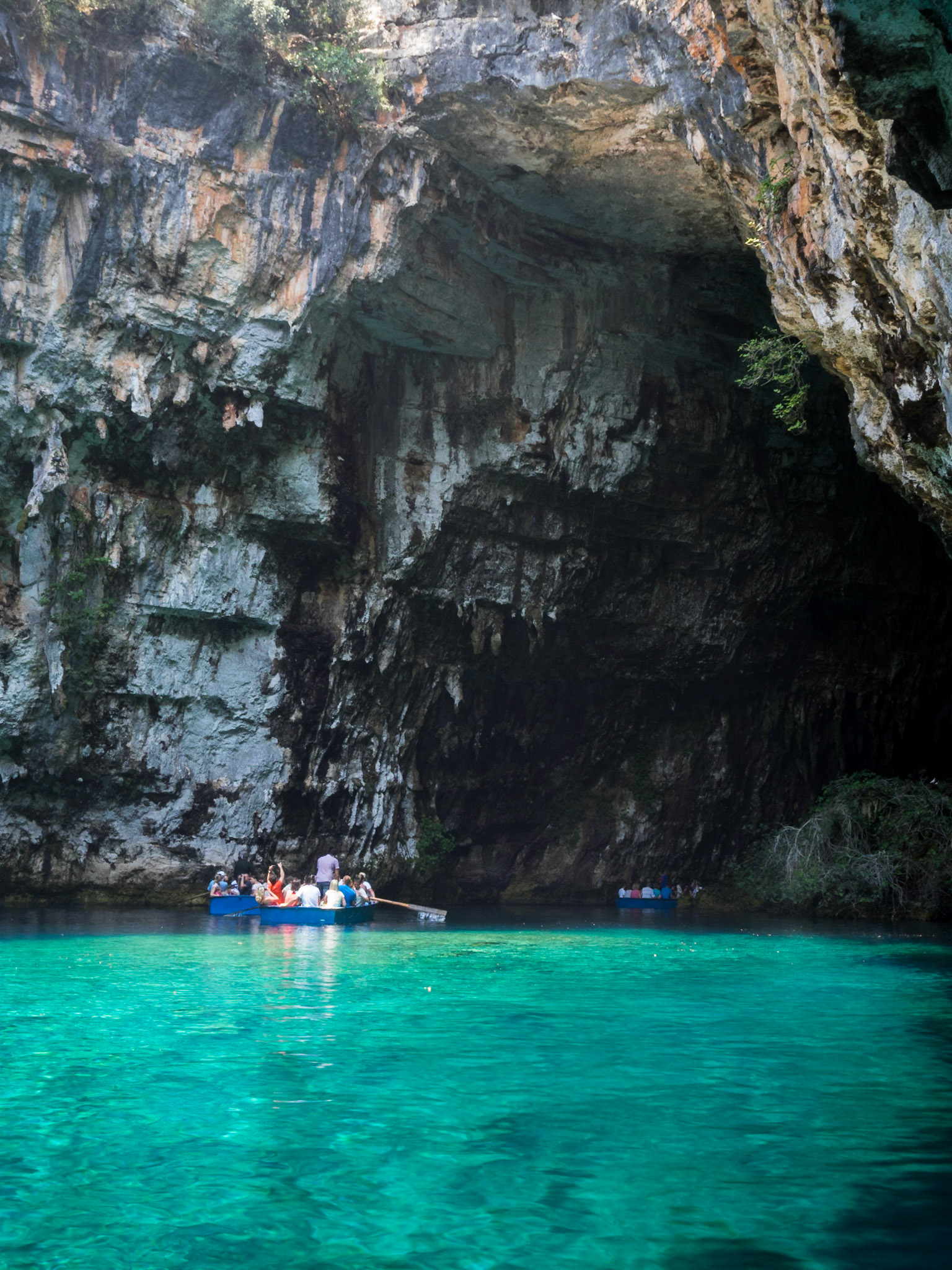 Tourists in a small boat inside the Melissani caves