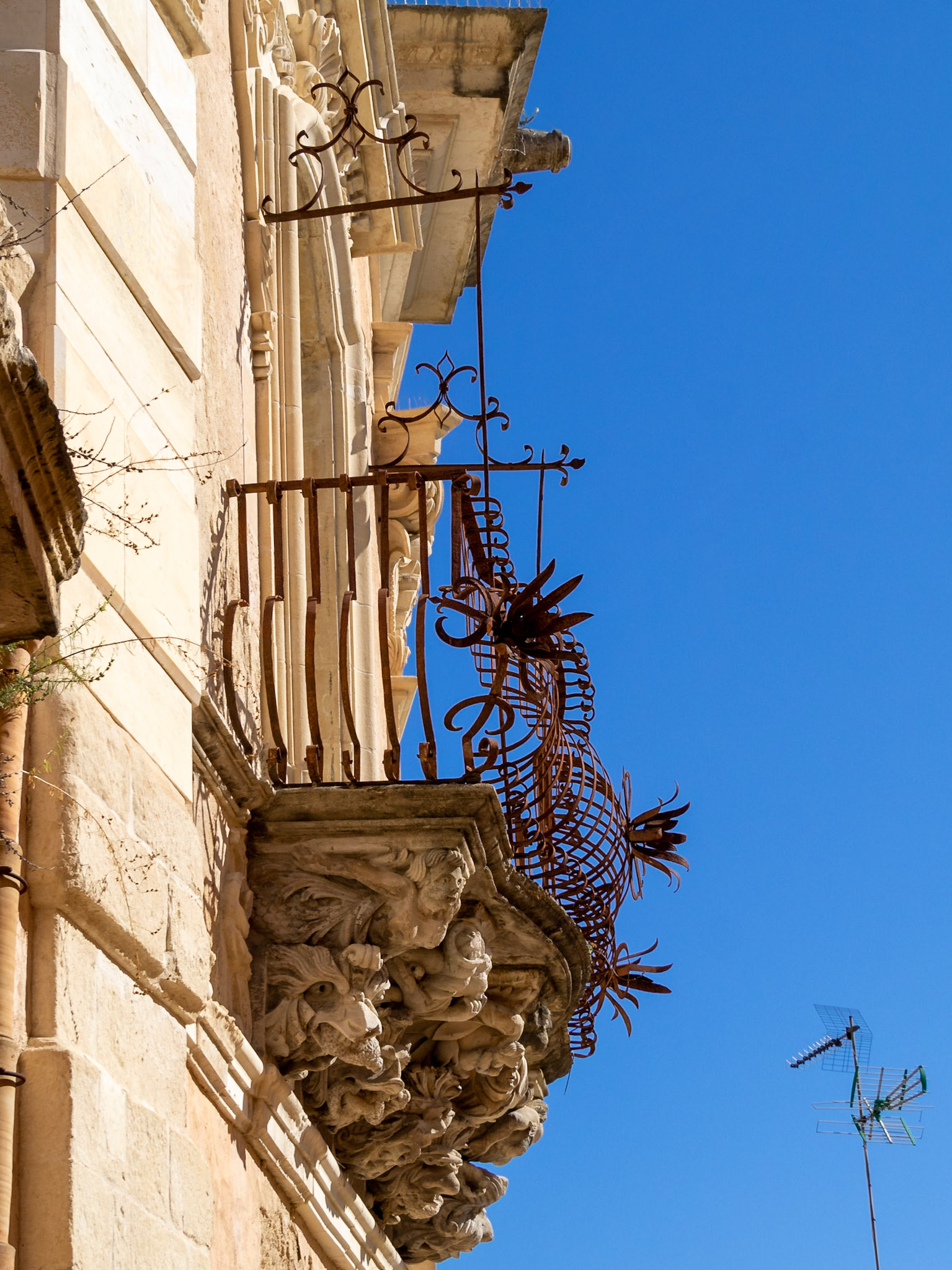 Side view of a stone carved balcony of the baroque Palazzo Cosentini, Ragusa