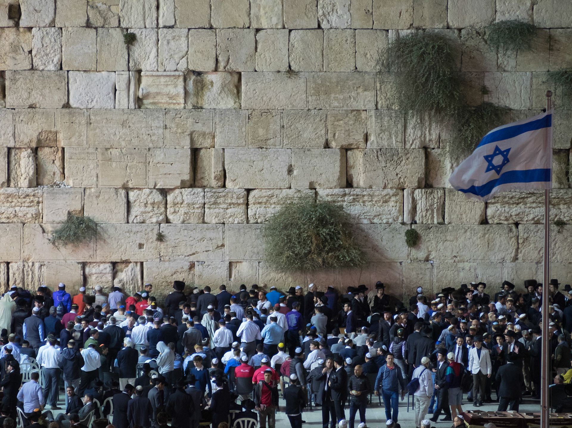 Celebrating Sabbath by the Western Wall under the Israeli flag