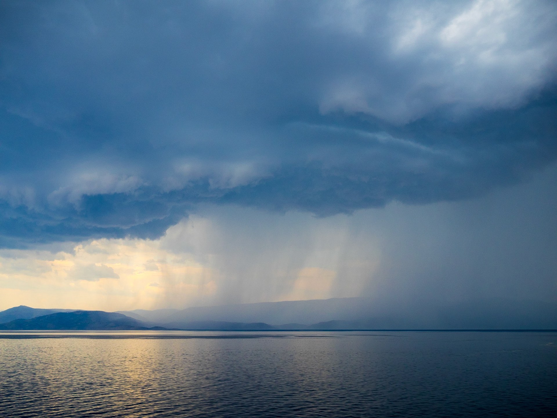 Dark stormy clouds over the Ionian sea between continental Greece and Corfu island