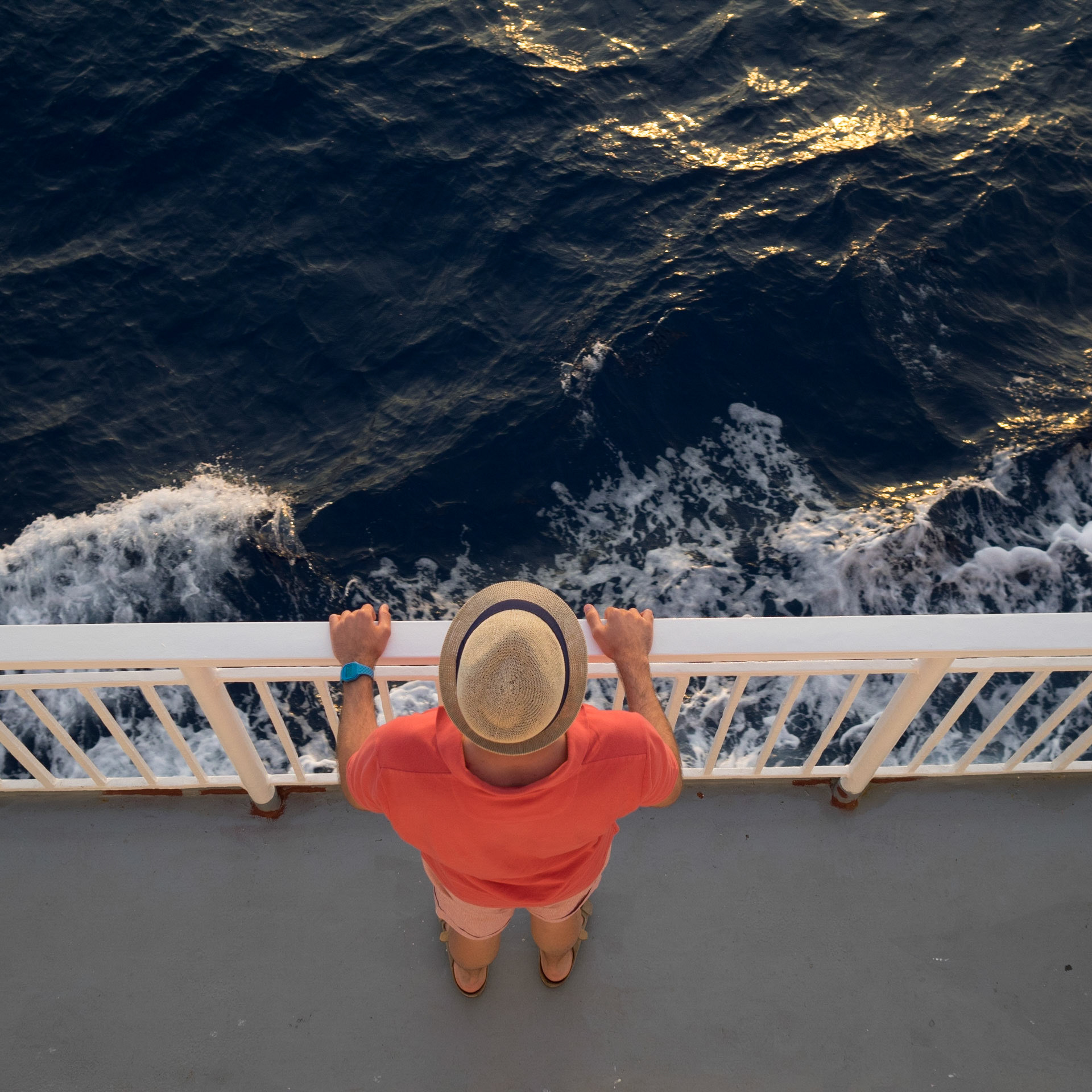 Top down view of a man traveling in a ferry boat in the Ionian sea