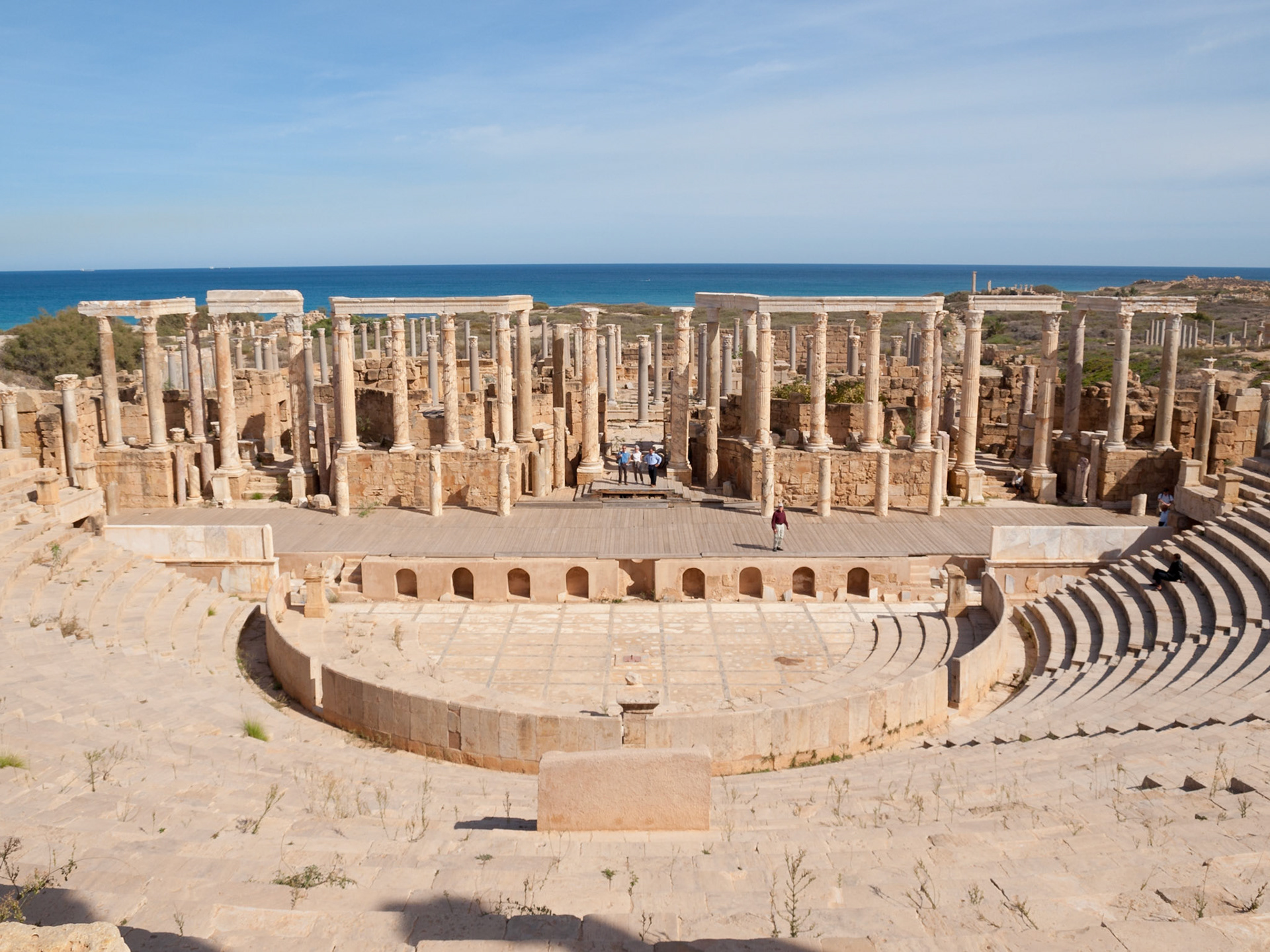 Leptis Magna ruins of the theater stage and seats with the Mediterranean sea in background