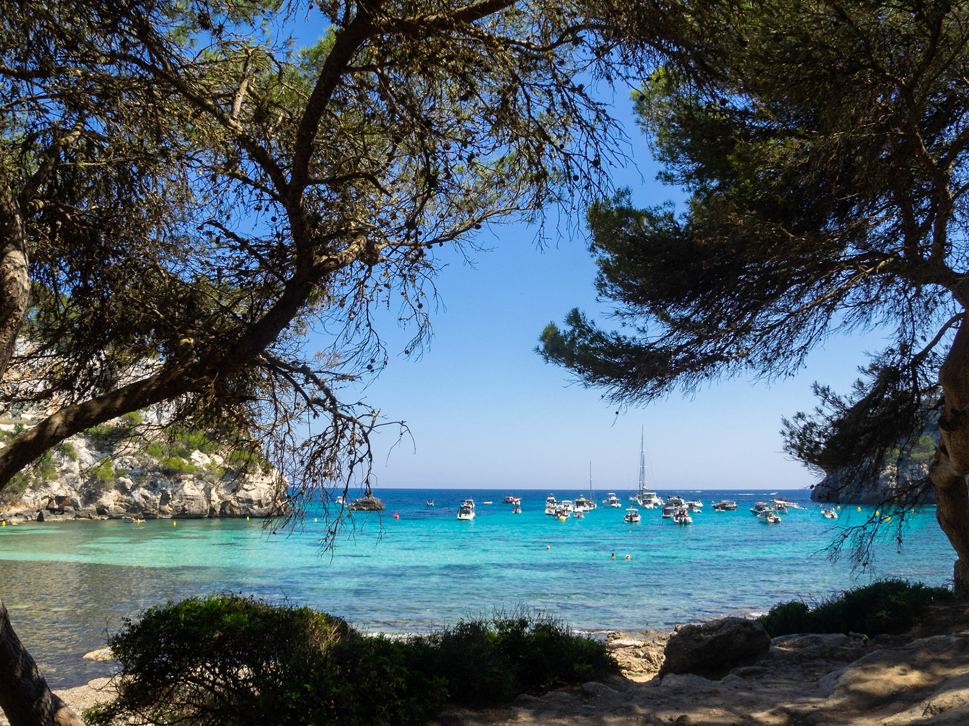 Boats in the horizon at Cala Macarella, Menorca