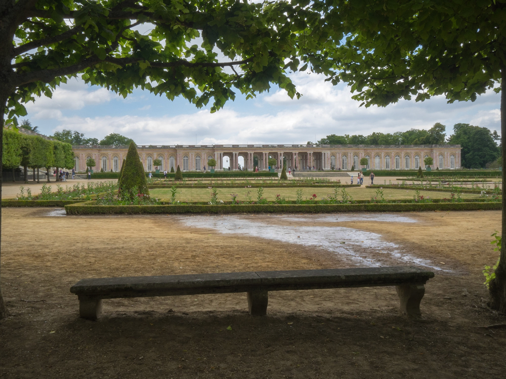 The Grand Trianon seen from the park behind a bench
