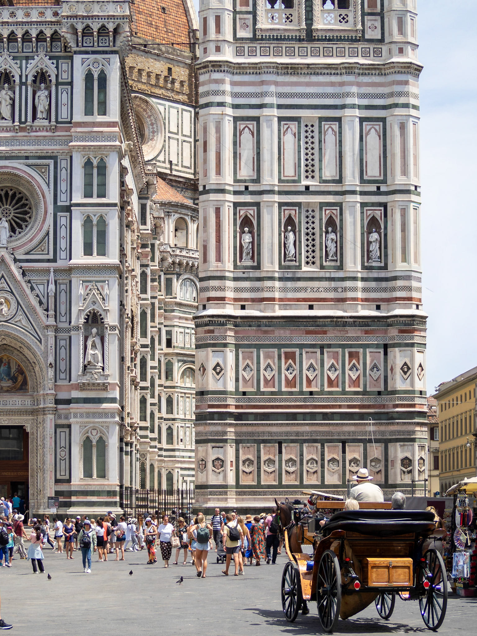 A horse chariot passes by Piazza di San Giovanni, Florence