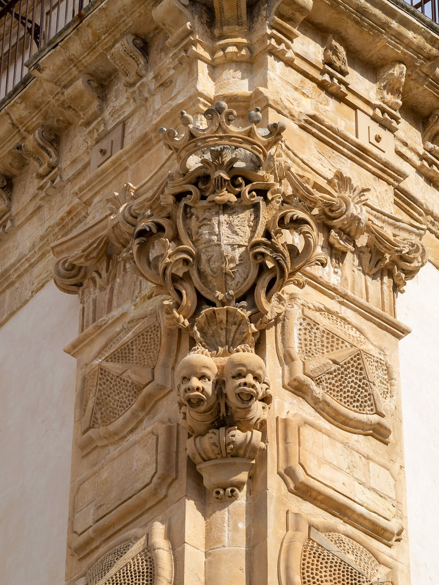 Smiling black slaves heads under the blazon of the Baroque Palazzo Beneventano, Scicli