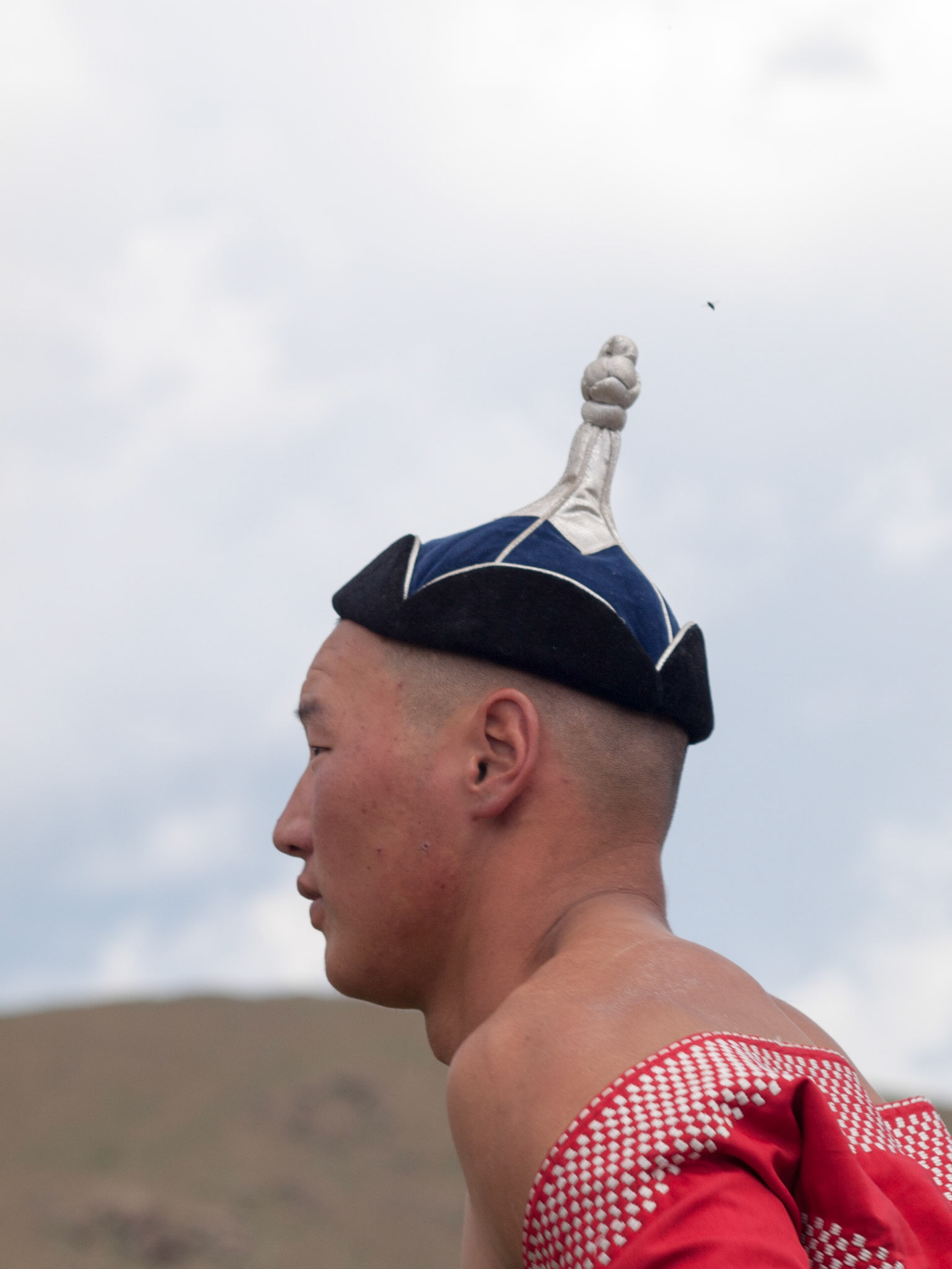 Man wearing traditional Mongolian hat in Naadam