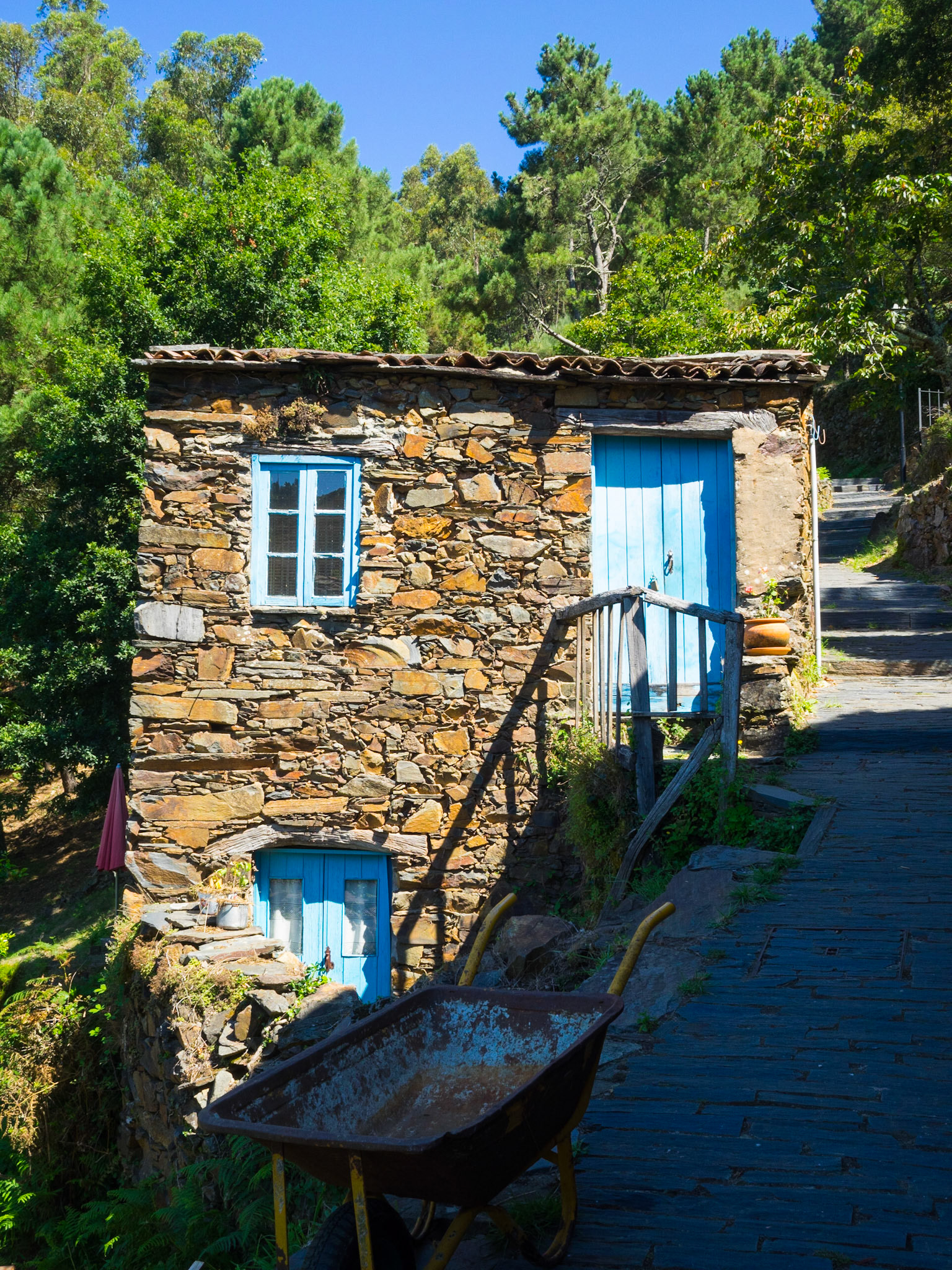 Cerdeira schist hamlet stone house in front of the forest trees