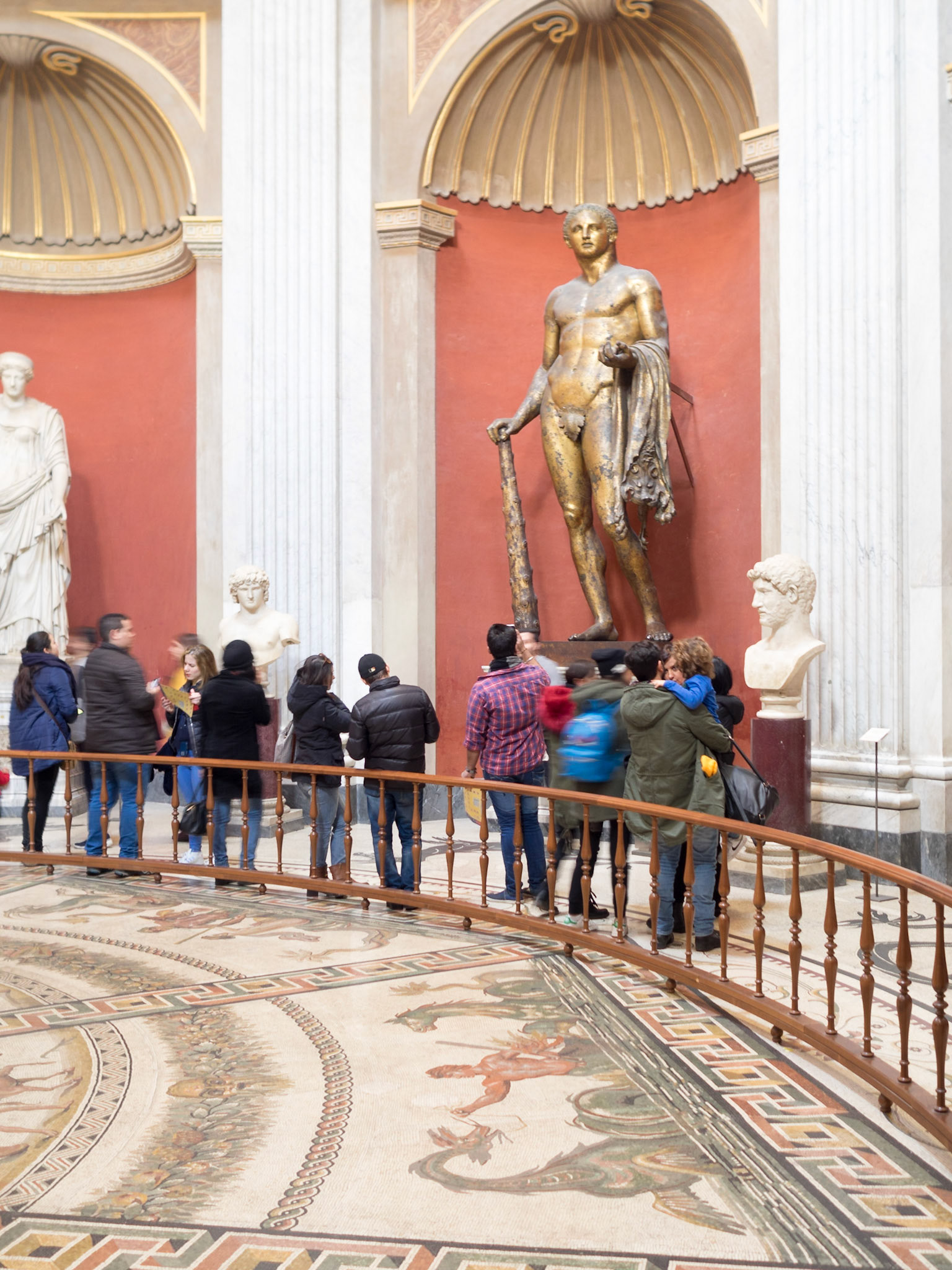 Visitors to the Vatican Museum admiring the art works