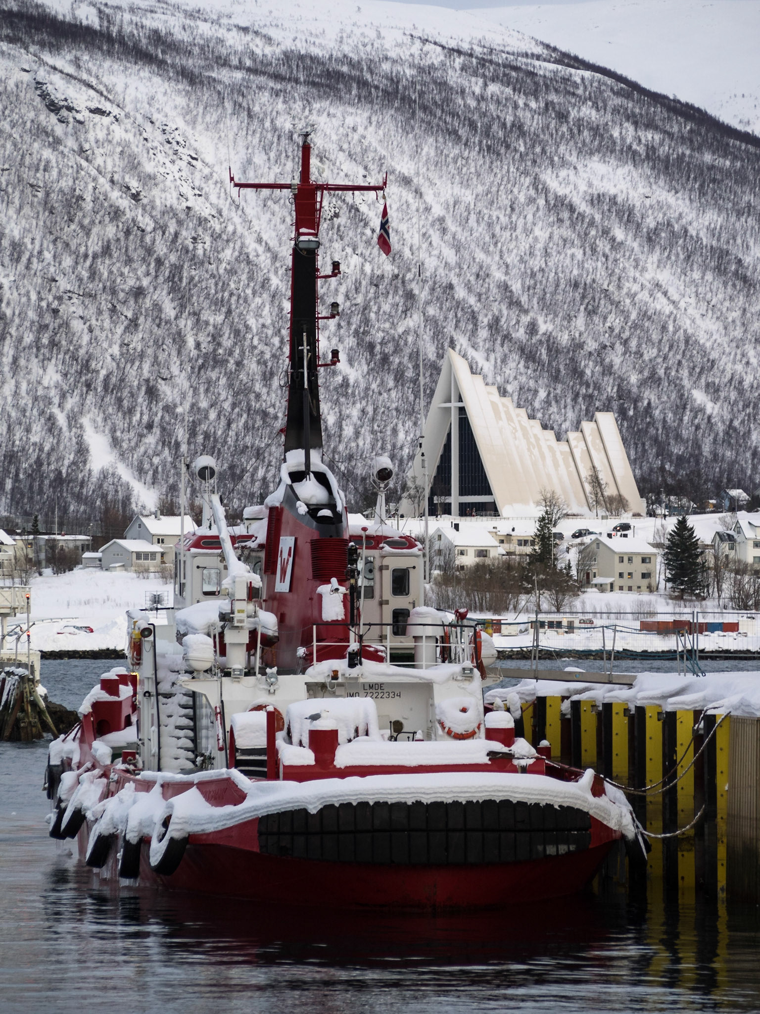 Snow covered boat in Tromso port