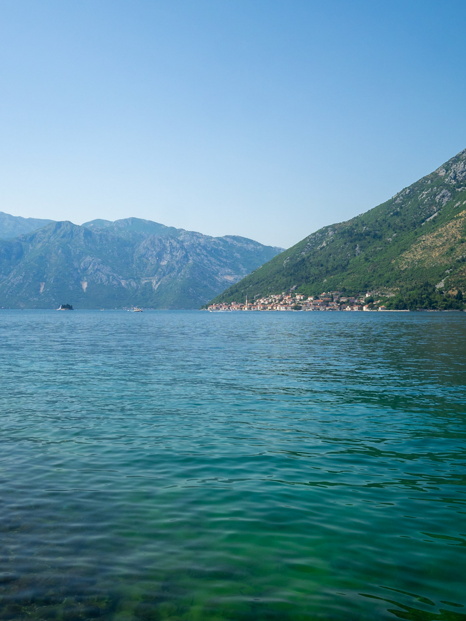 Turquoise waters of Kotor Bay with Perast in the horizon, Montenegro