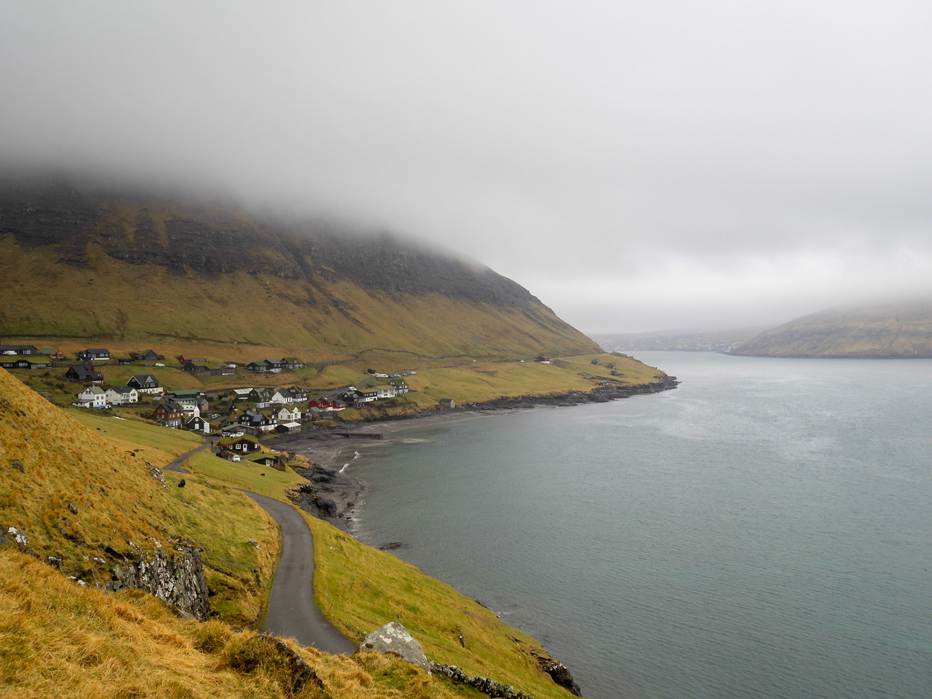 Bøur village bt yje sea and bellow the mountain