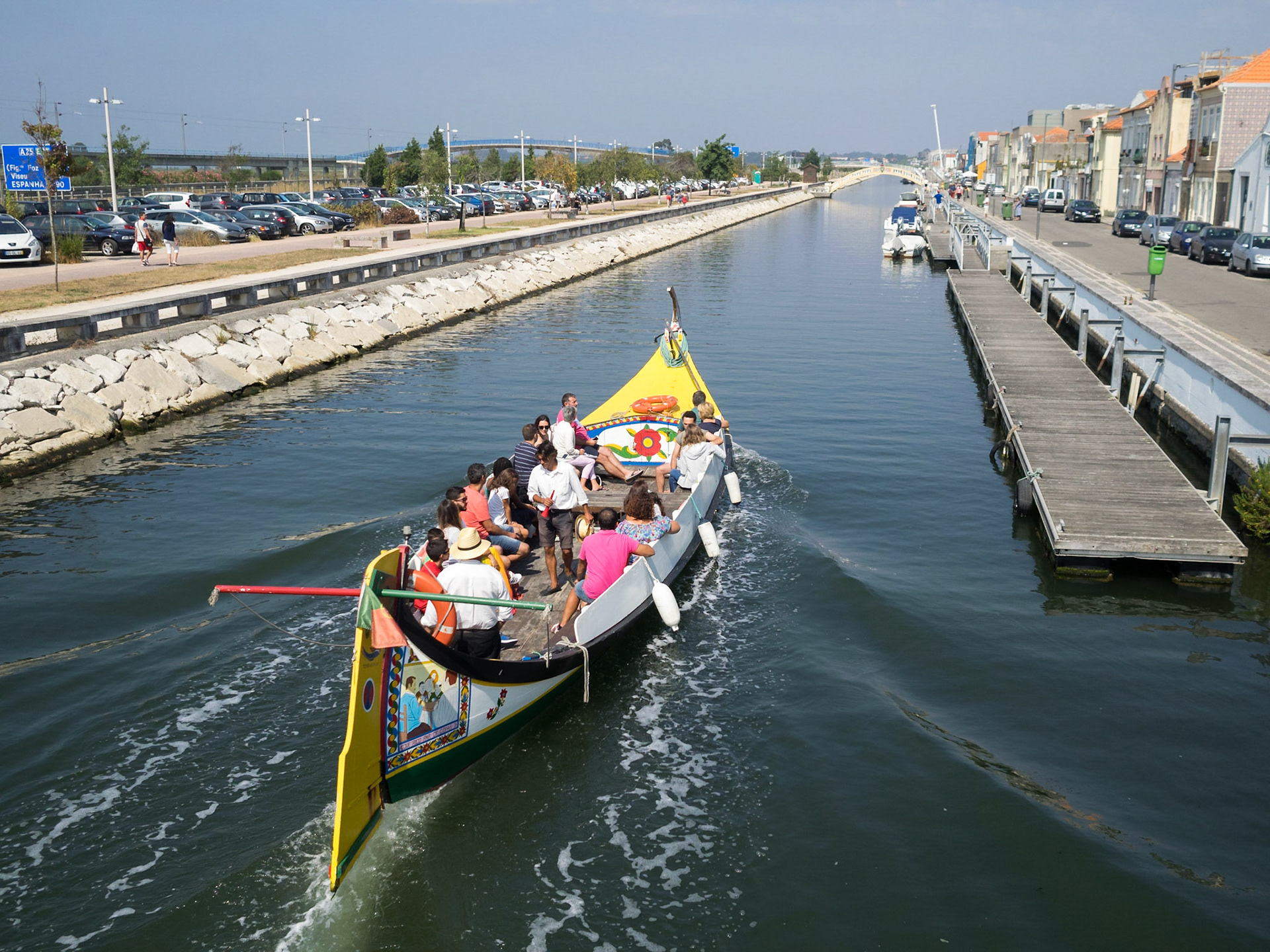 Tourists travelling the Aveiro canals in a typical moliceiro boat