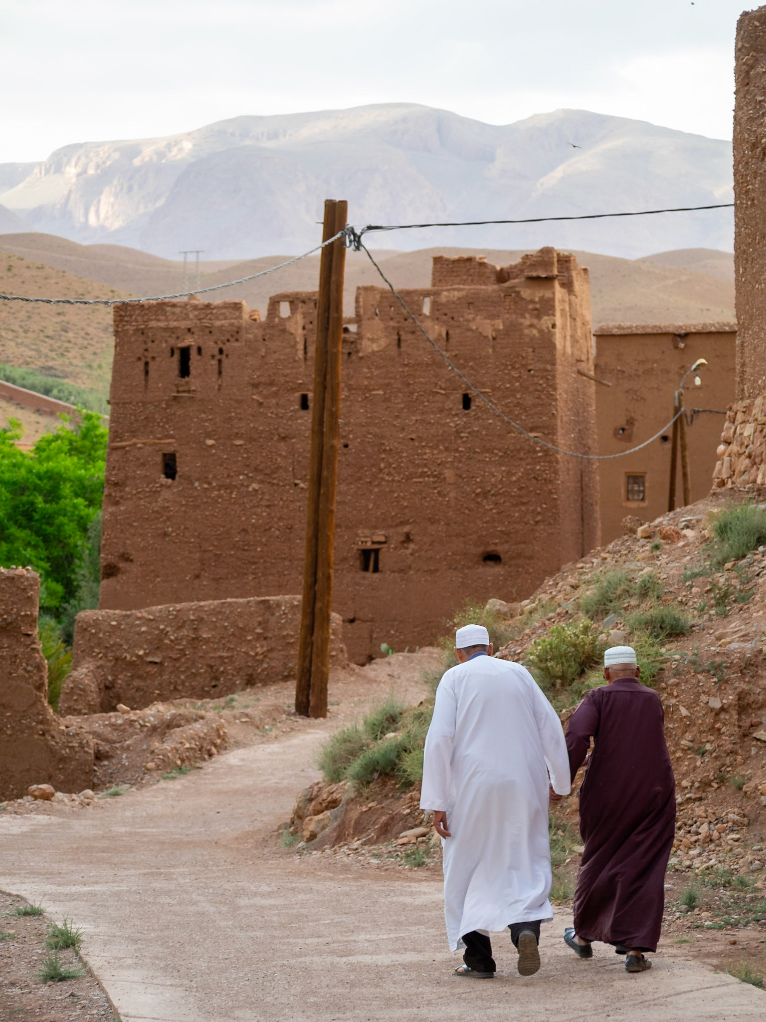 Two old men walk the streets of Ait Arbi, Morocco