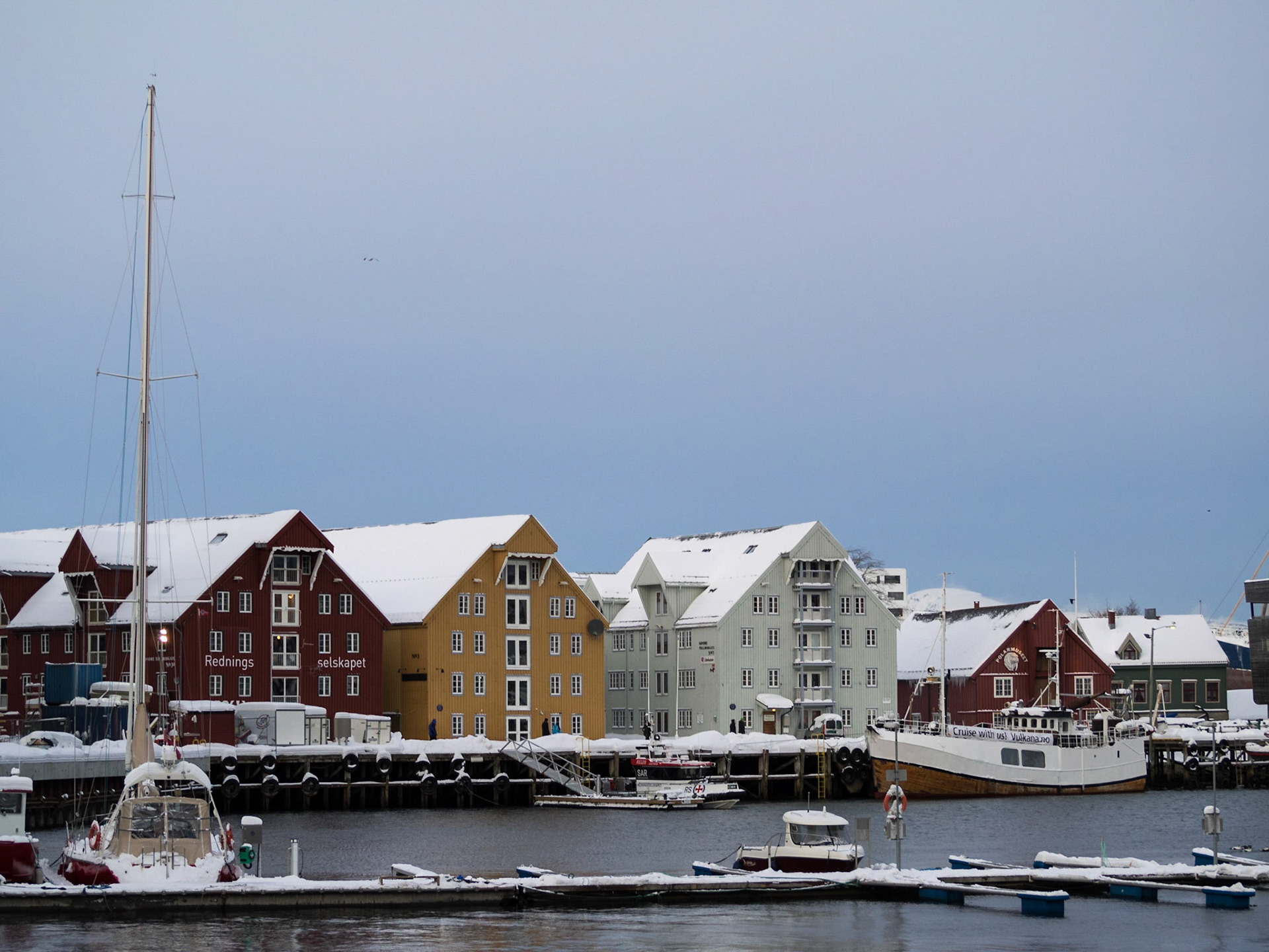 Traditional wooden buildings by the water in Tromso seafront