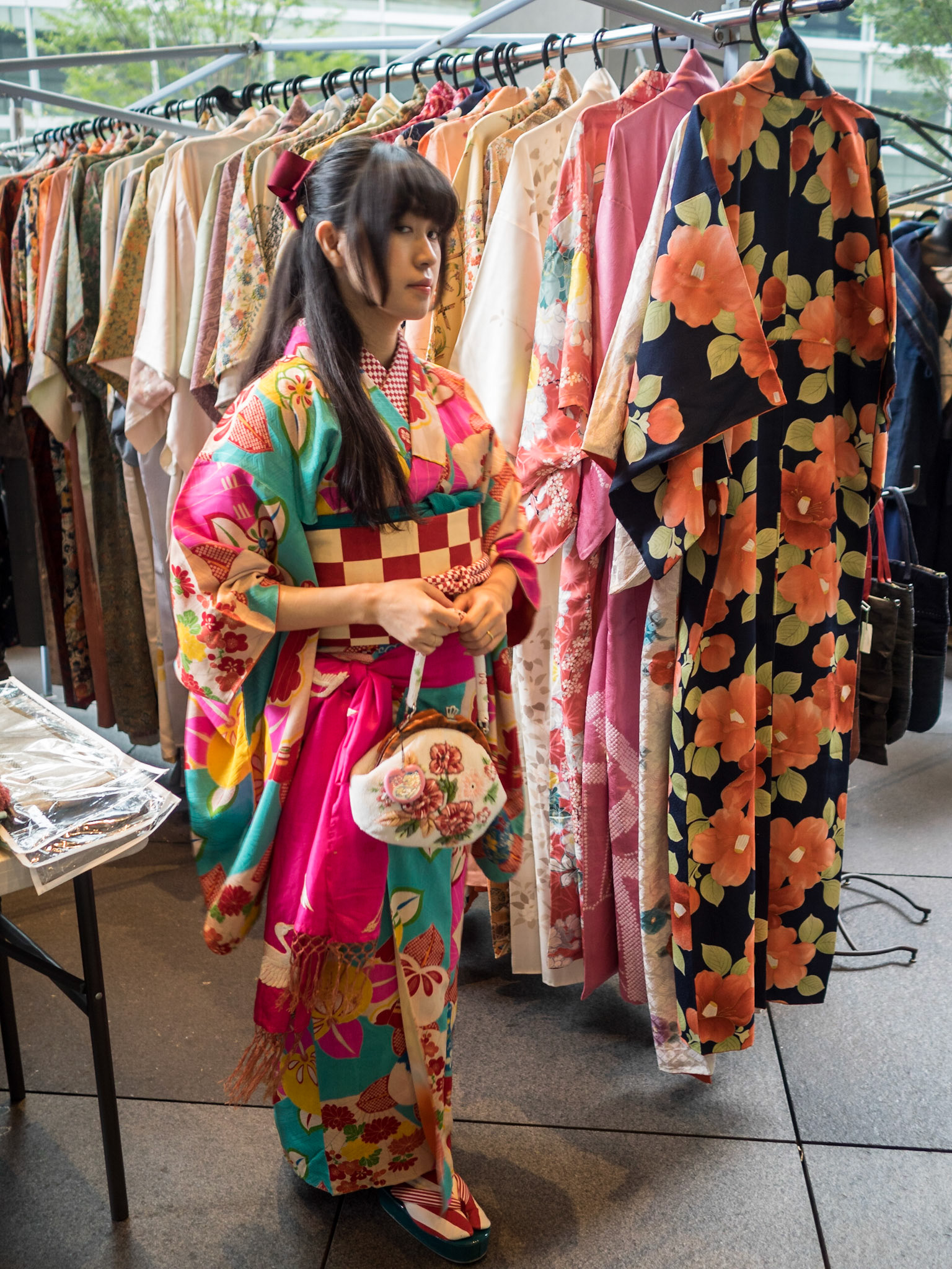 Woman dressed in colorful Geisha kimono costume shopping in the Marunouchi weekend flea market