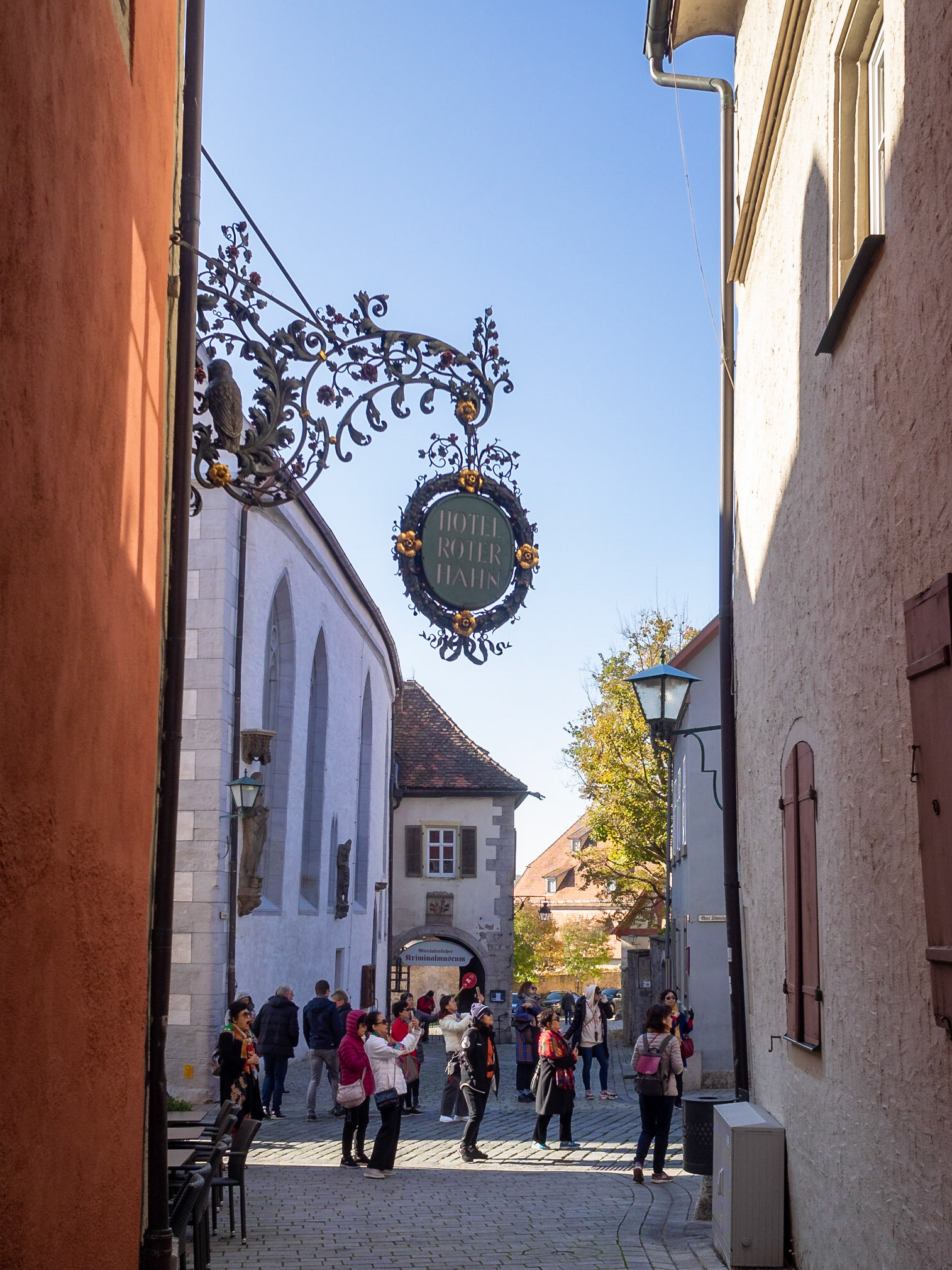 Tourists taking pictures in a street of Rothenburg ob der Tauber