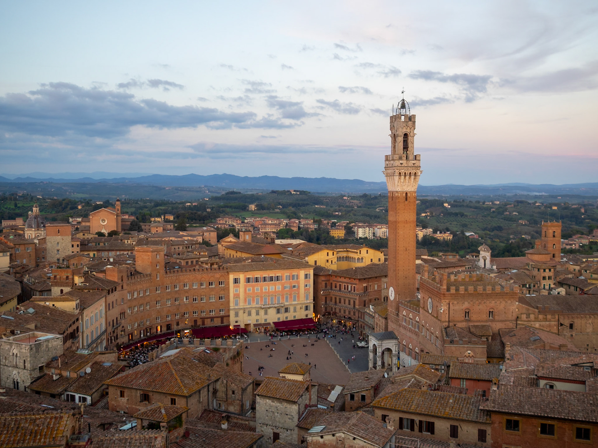 View of Siena Il Campo and Torre del Magia at dusk, over the roofs