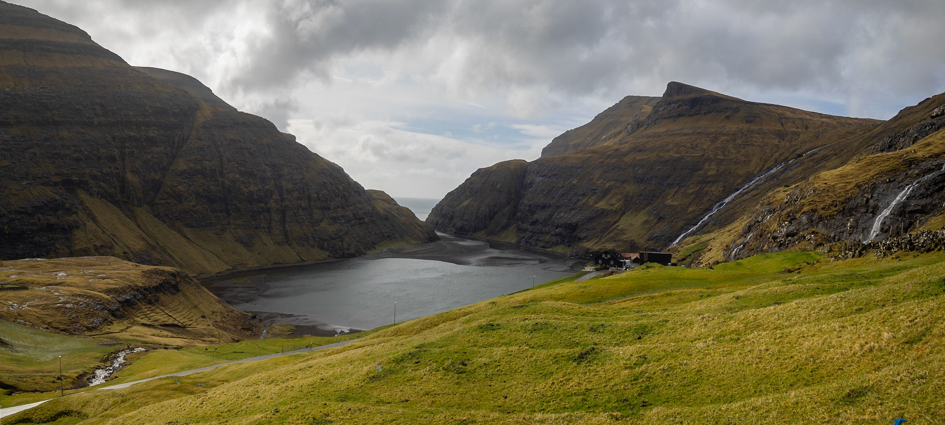 Saksun black sand tidal lagoon with the sea behind the mountains
