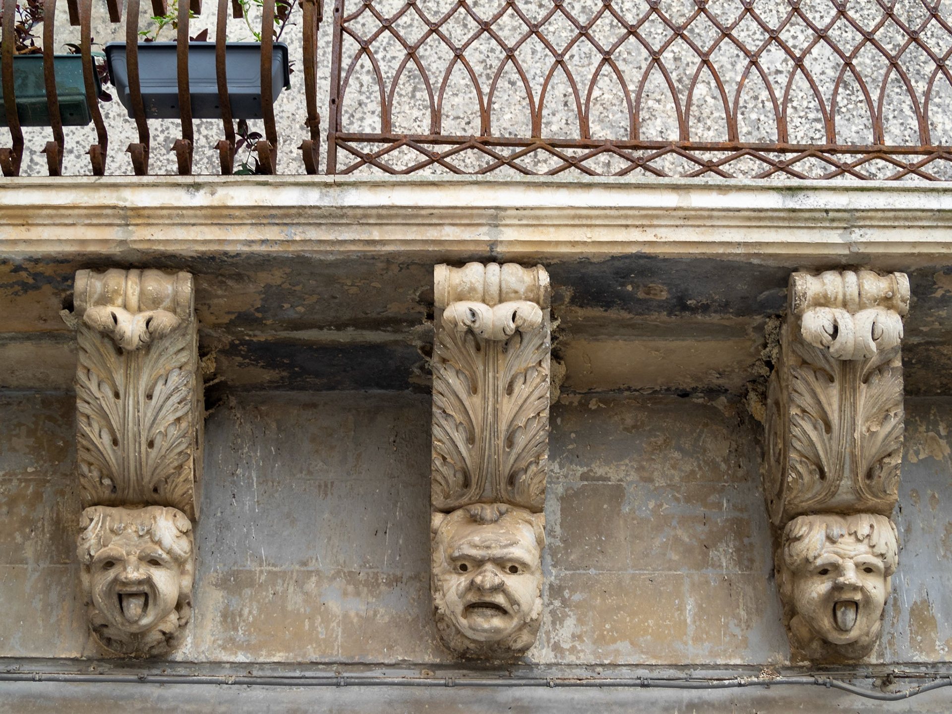 Detail of the figures support the balcony of Palazzo Caruso - Lombardo, Palazzolo Acreide