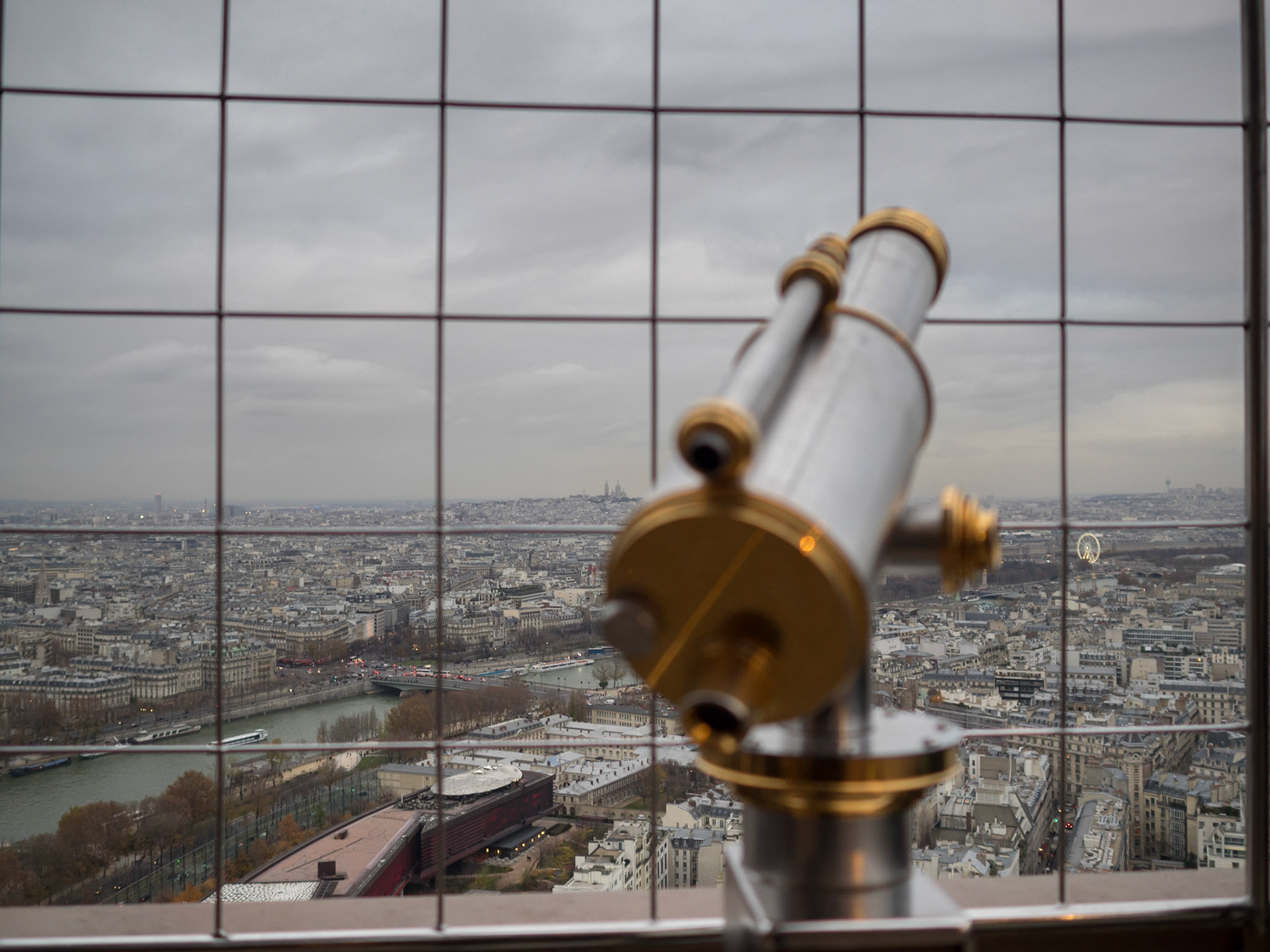 Paris city view from the top of the Eiffel tower with binocular