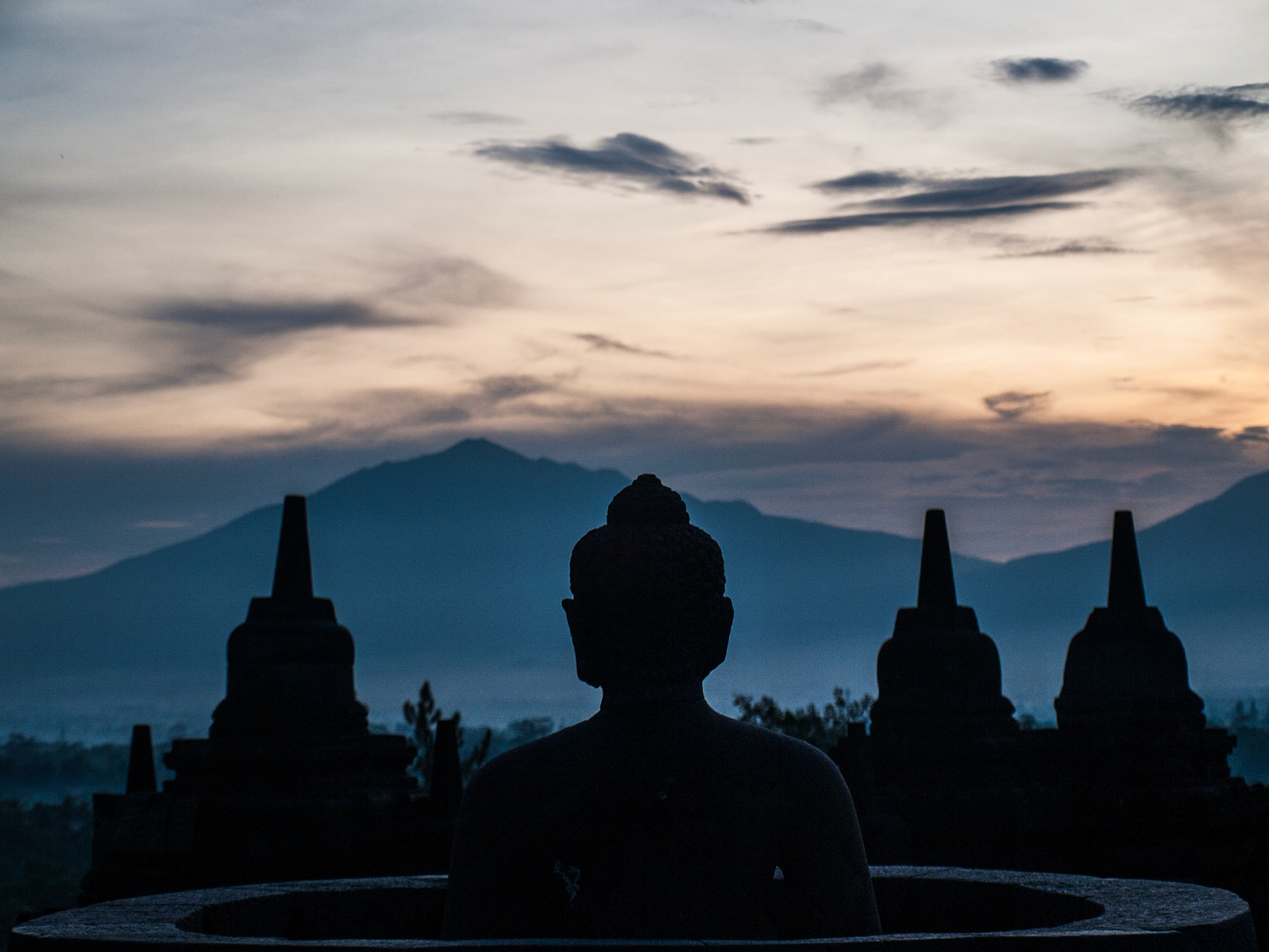 Buddha and stupa silhouettes in the dawn light, Borobudur temple