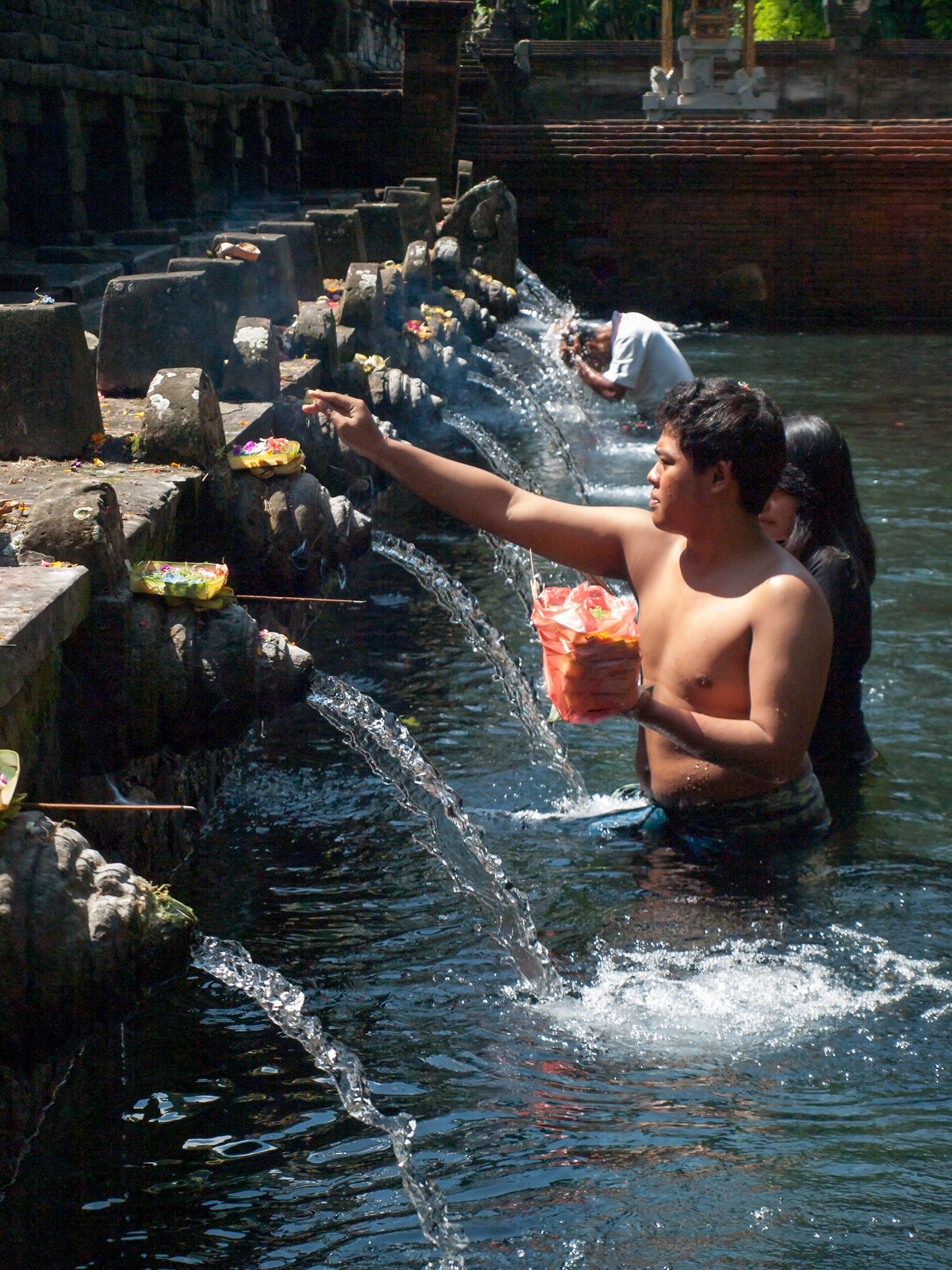 Hindu pilgrims inside Pura Tirta Empul holy water pool