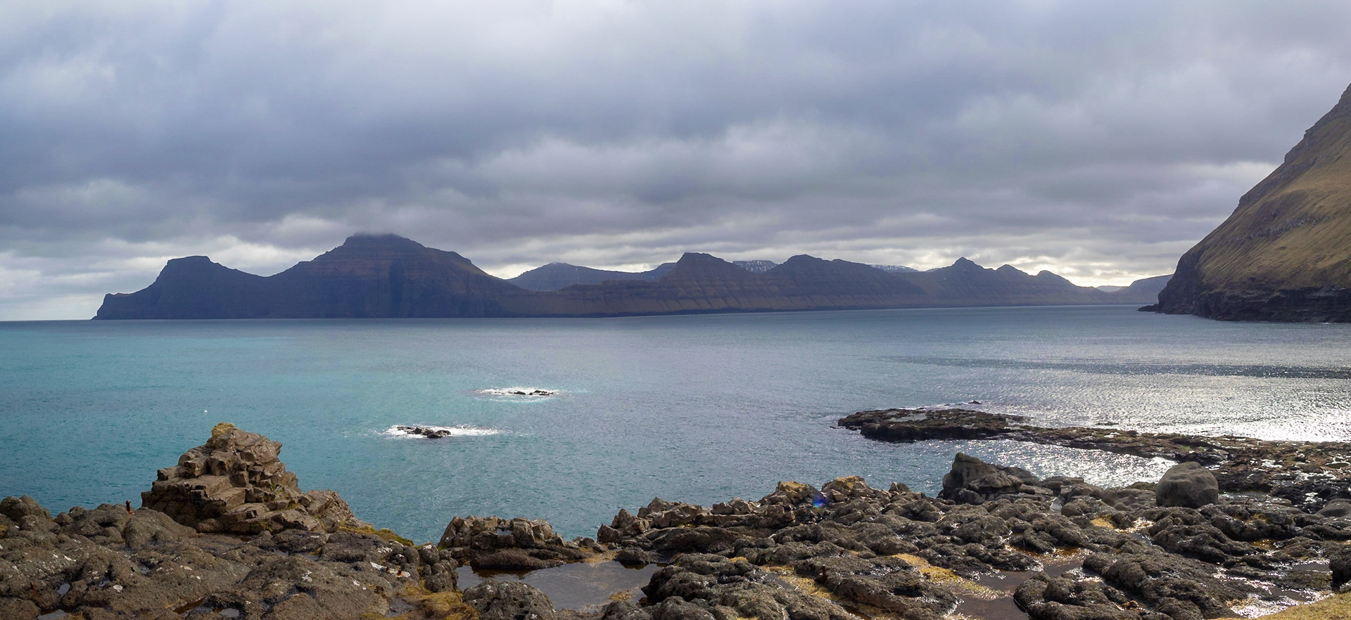 Djúpini sound seen from Gjógv with Kalsoy island silhouette on the horizon