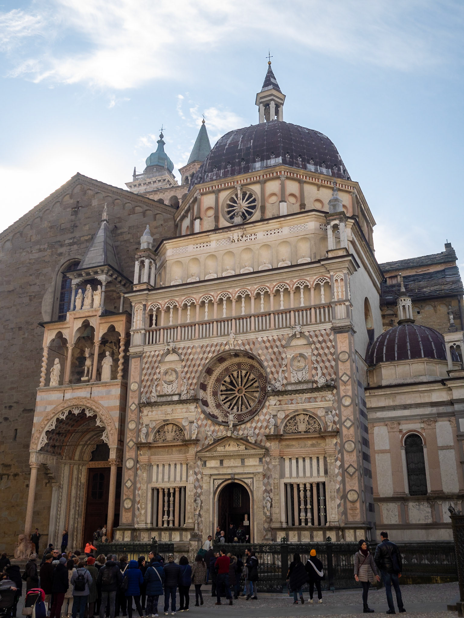 Tourists in Bergamo Duomo Square admiring the facade of Cappella Colleoni