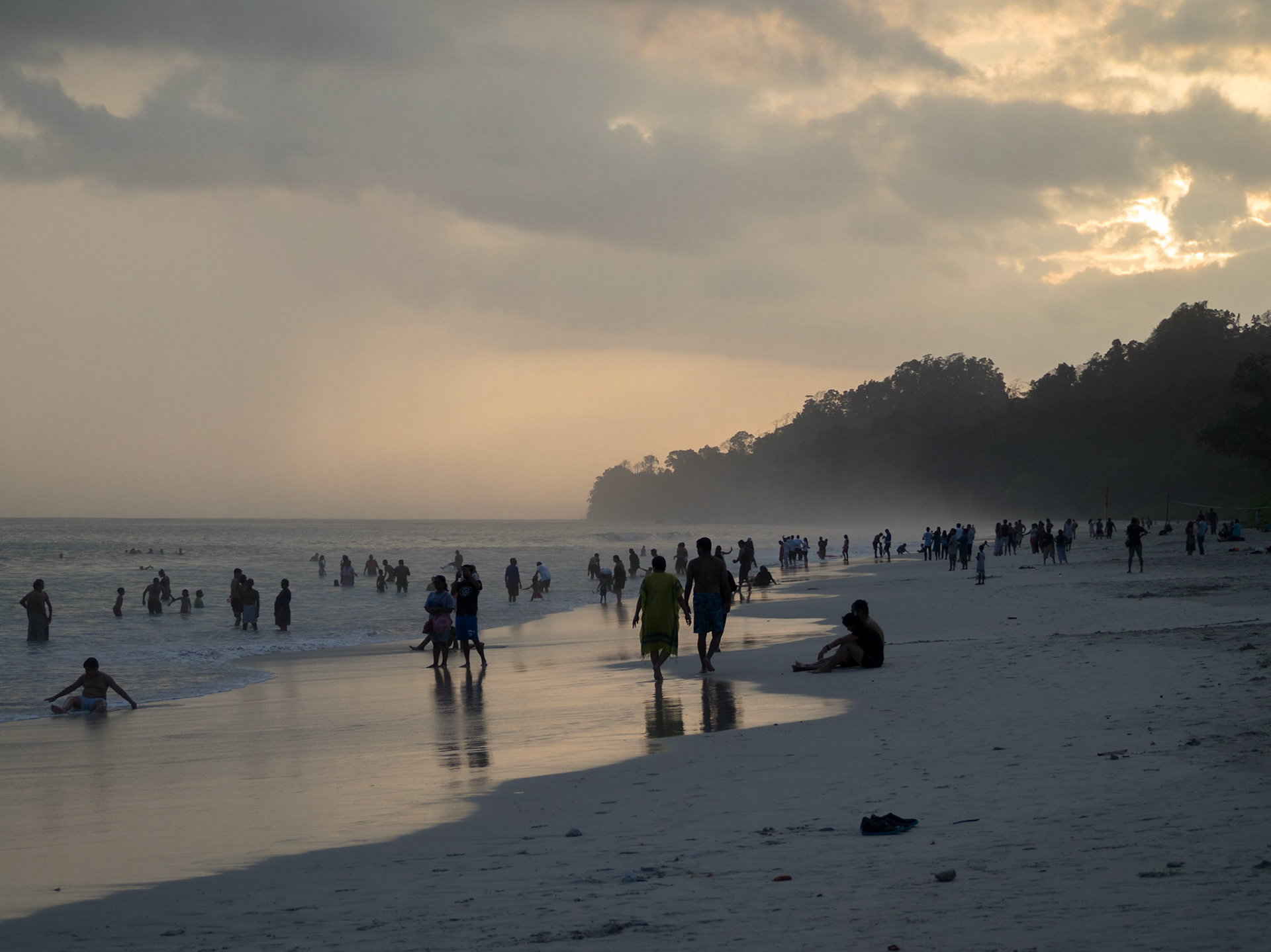 People silhouettes at sunset in Radhanagar beach, Havelock