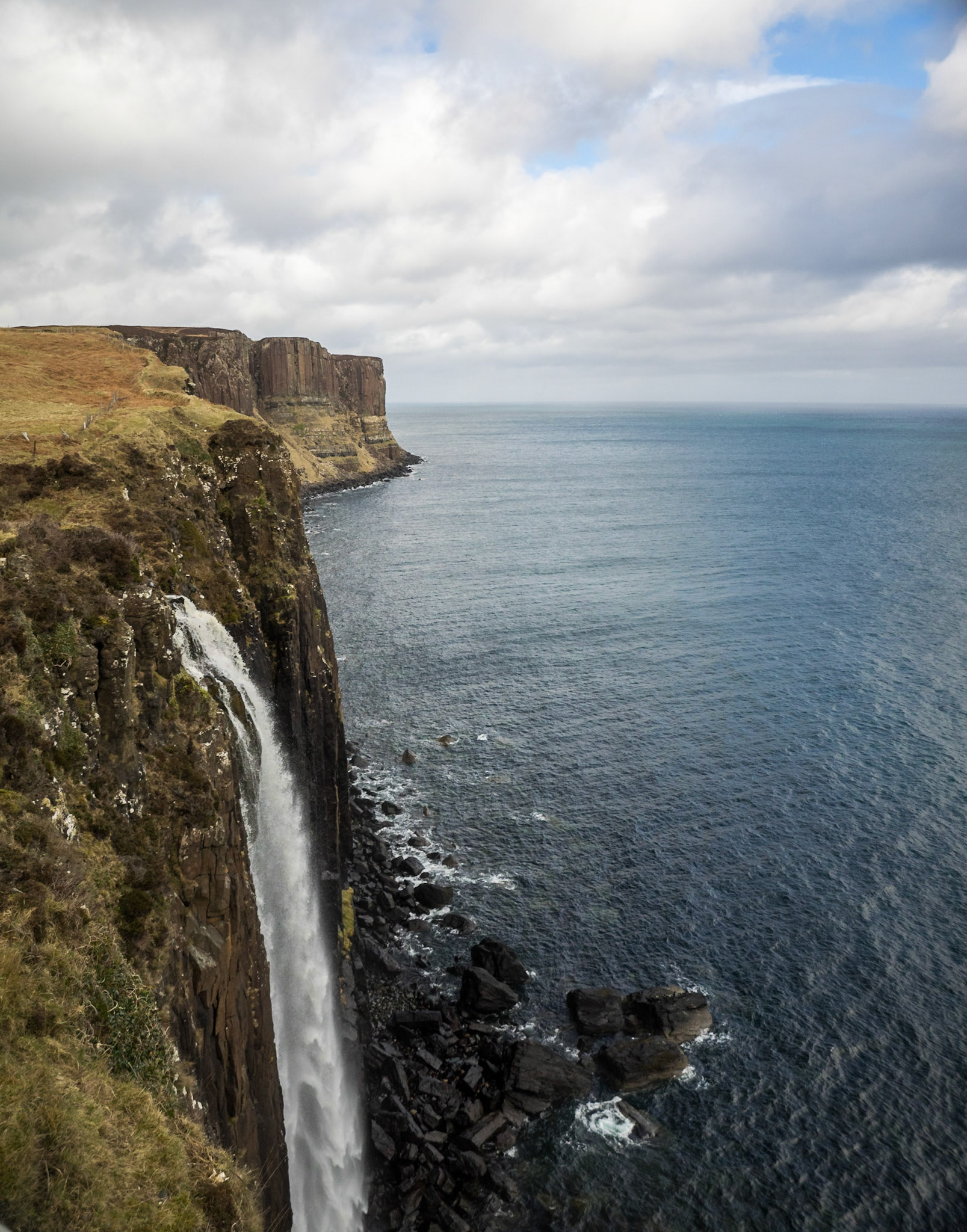 Kilt Rock waterfall crashing into the sea from the cliffs of Totternish peninsula in the Isle of Skye