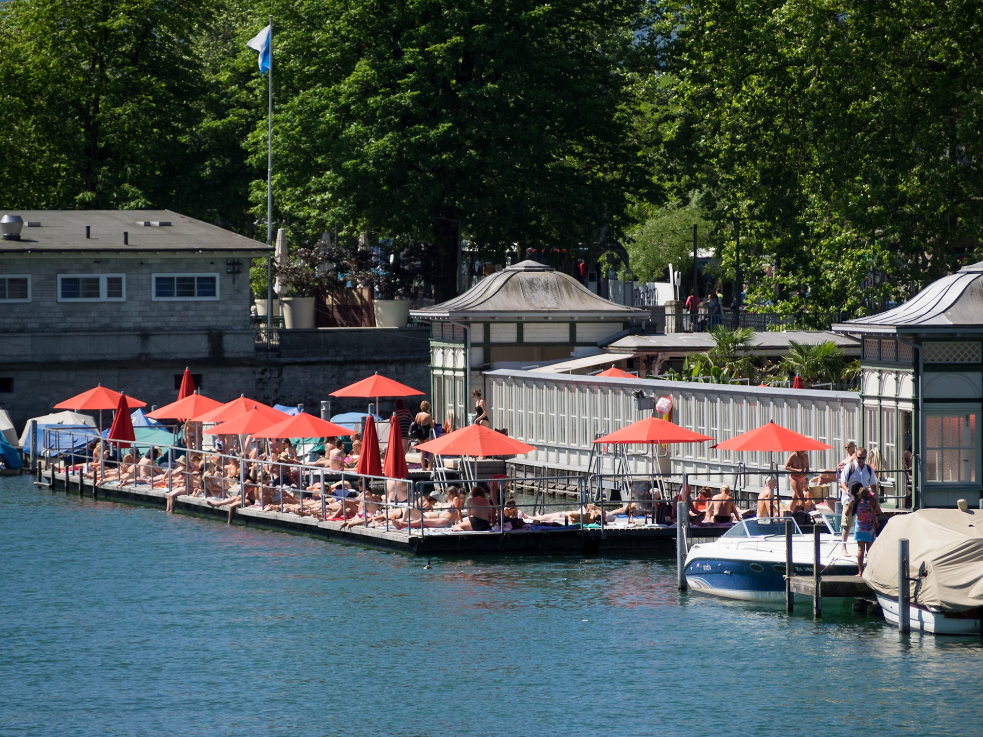 Sunbathing in Zurich by Limmat River in Frauenbad Stadthausquai