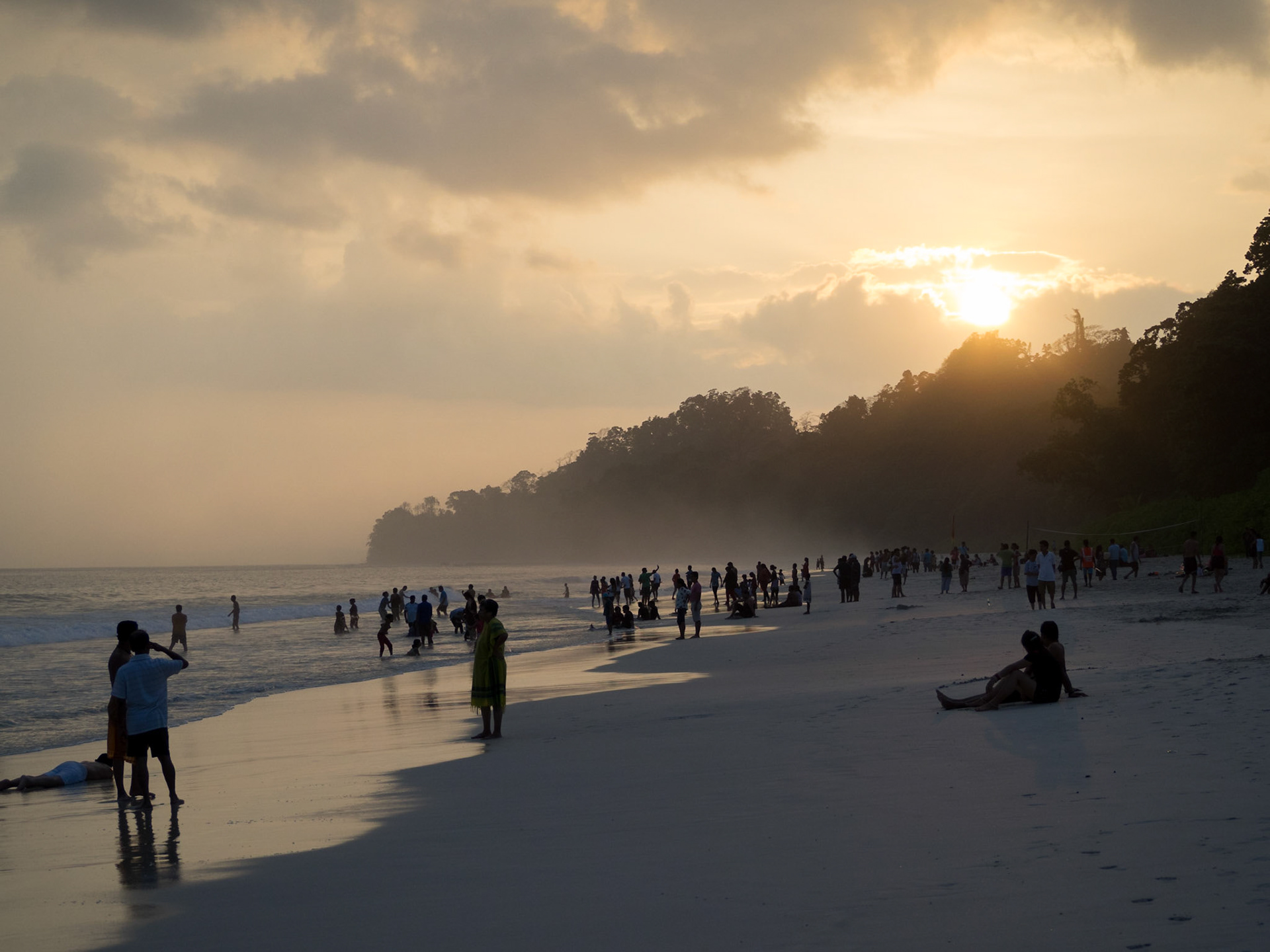 People silhouettes at sunset in Radhanagar beach, Havelock