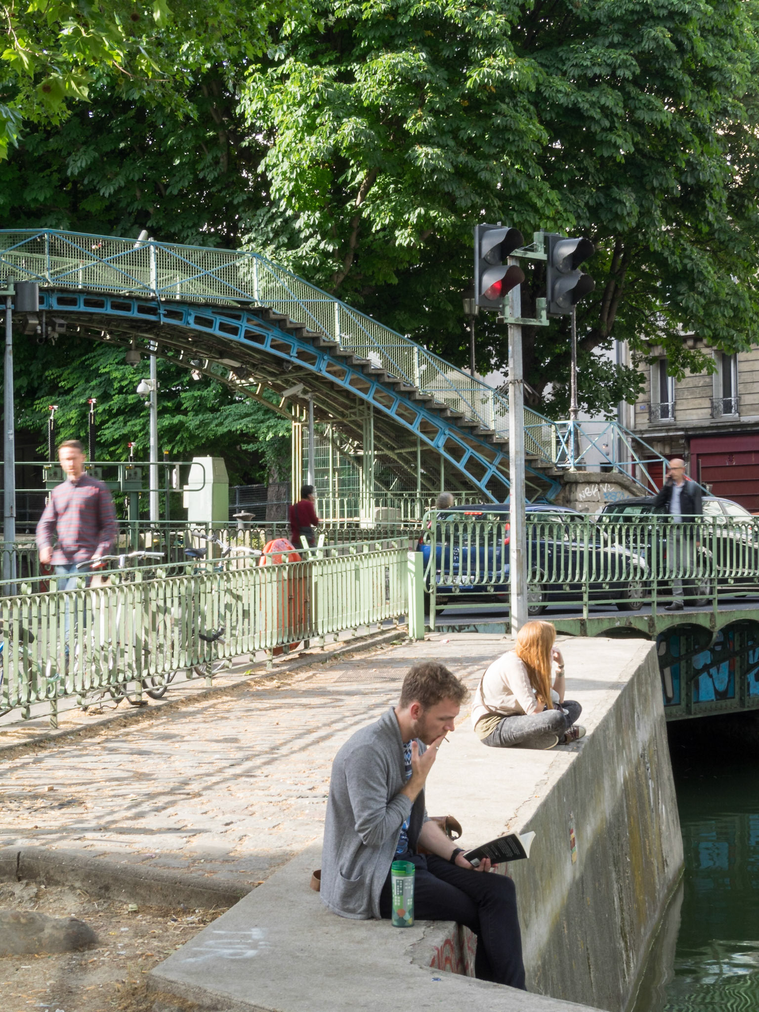 People reading and relaxing around Canal Saint-Martin
