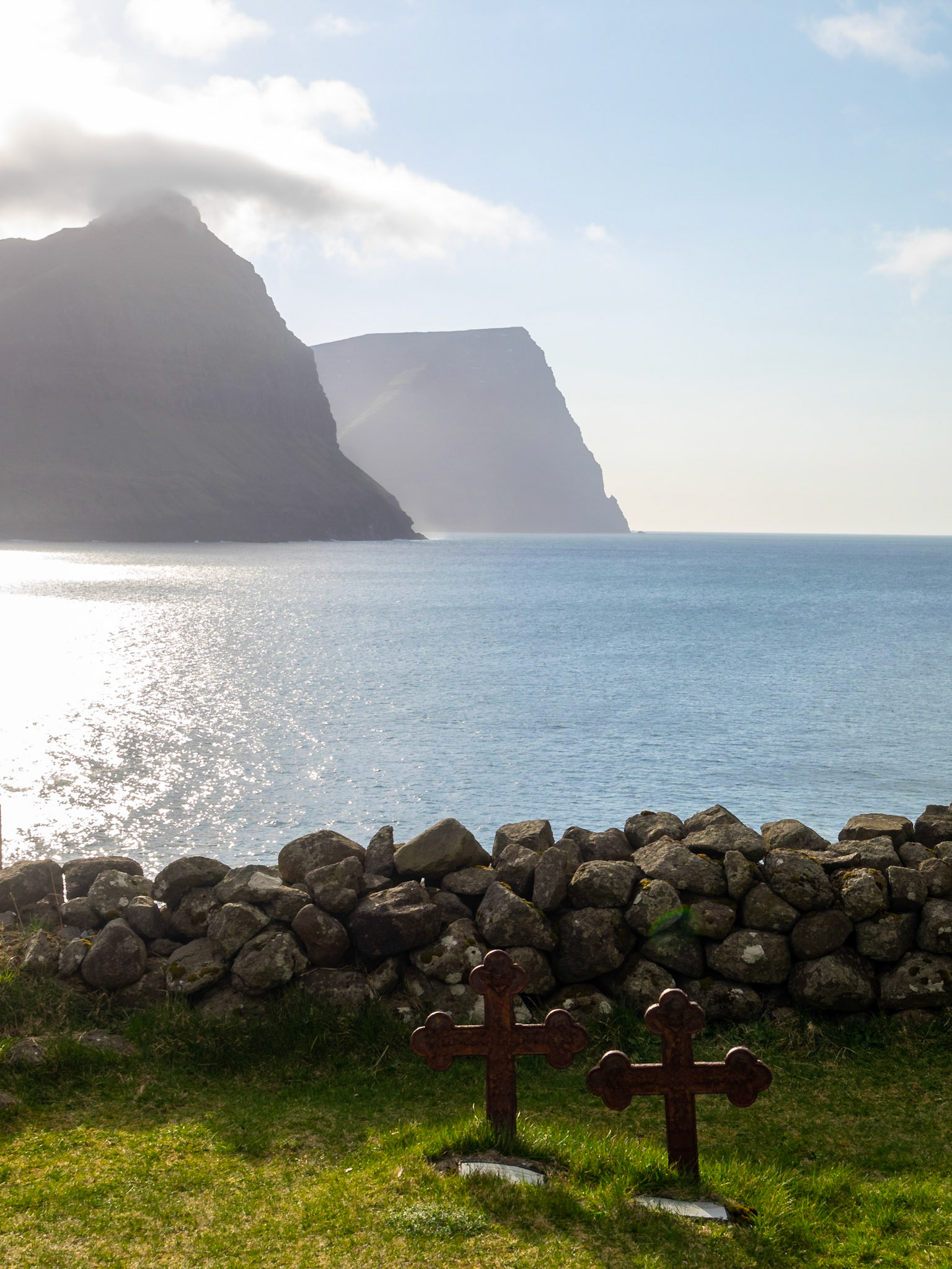 Burdoy and Kunoy silhouettes seen across the sea from Vidareidi graveyard