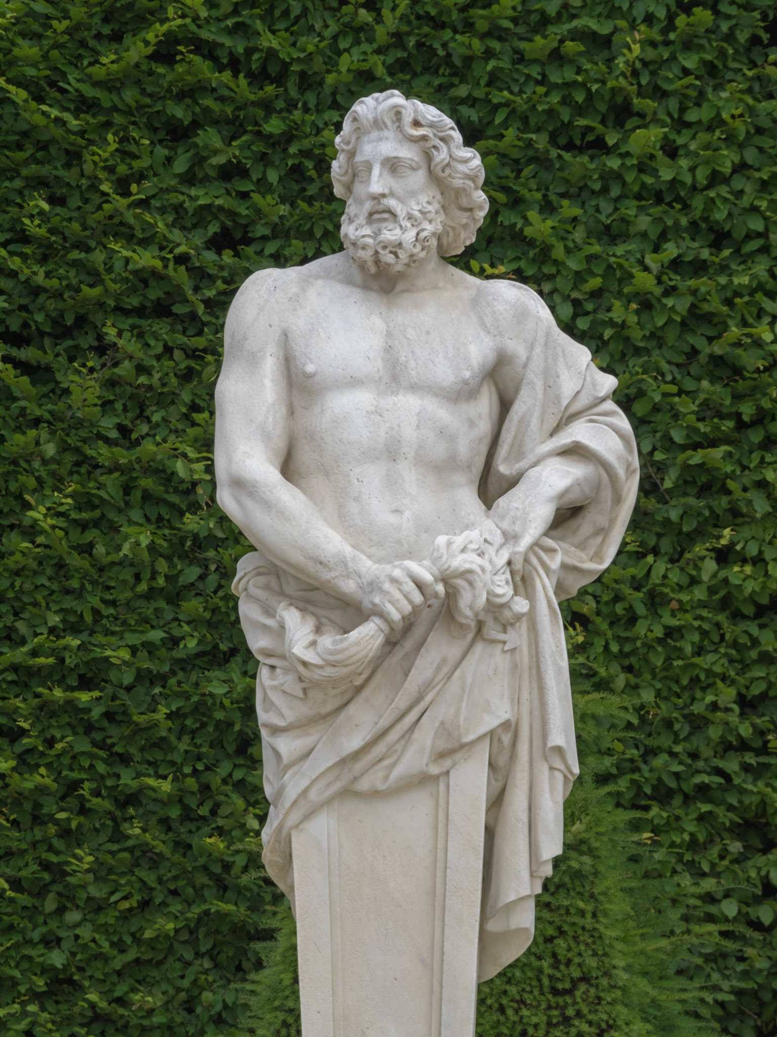 Versailles garden statue of a man white naked torso