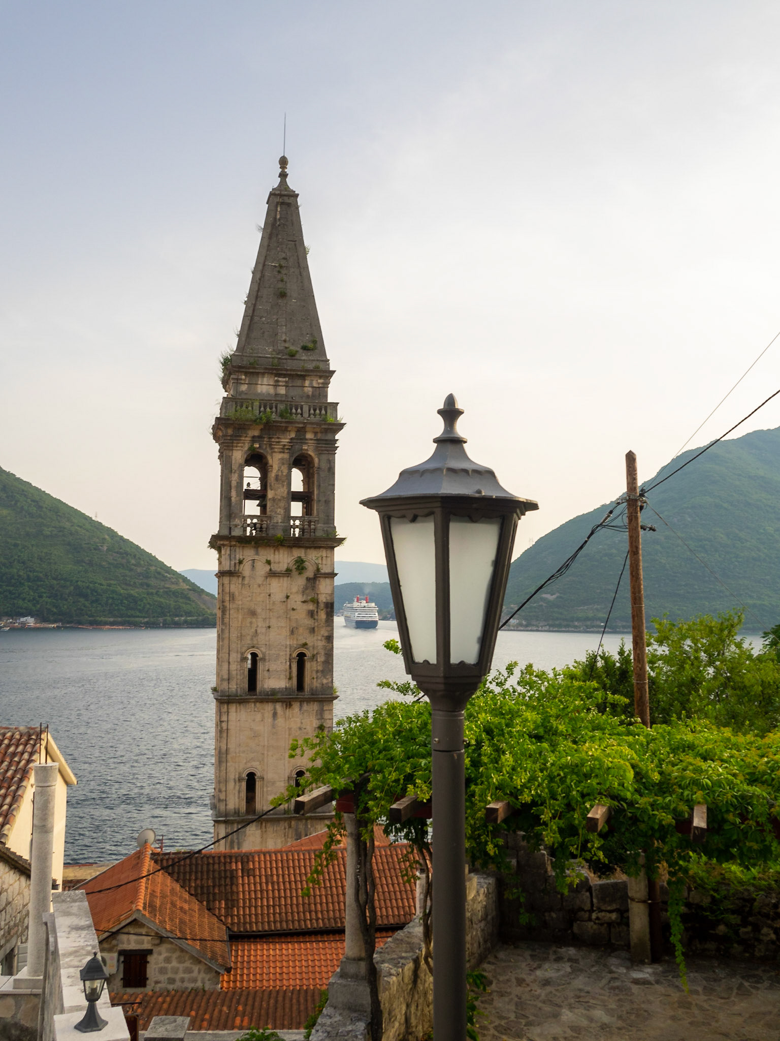 Church of Saint Nicholas bell tower over Perast roofs