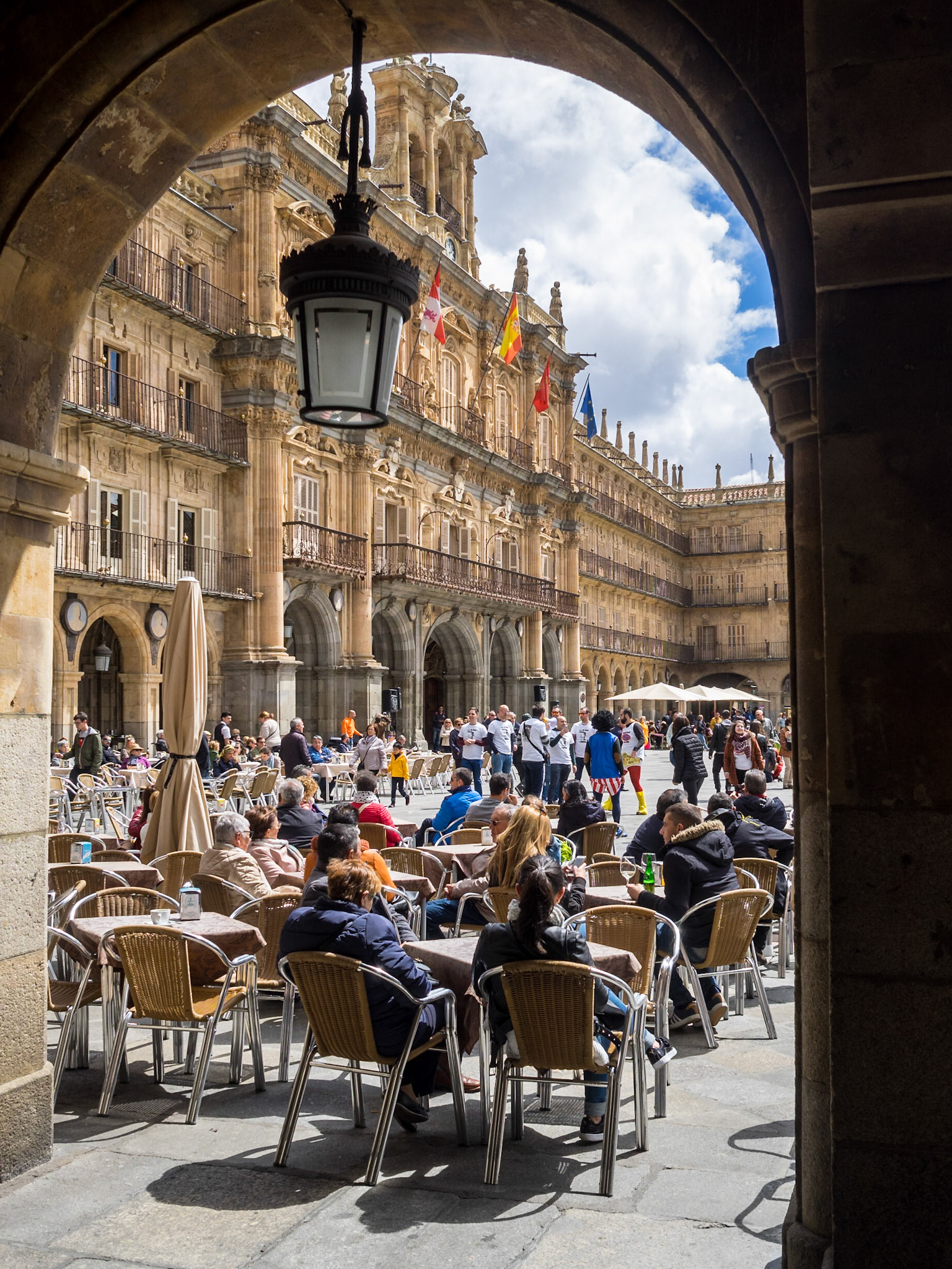 People in the sun at a cafe in Plaza Mayor, Salamanca
