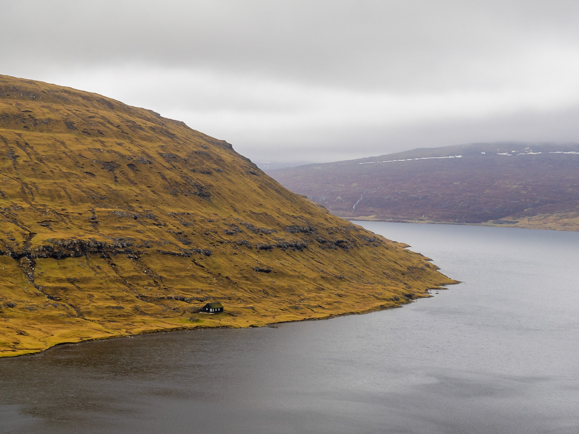 Turf roof house below the Borgarheyggjur mountain by lake Leitisvatn