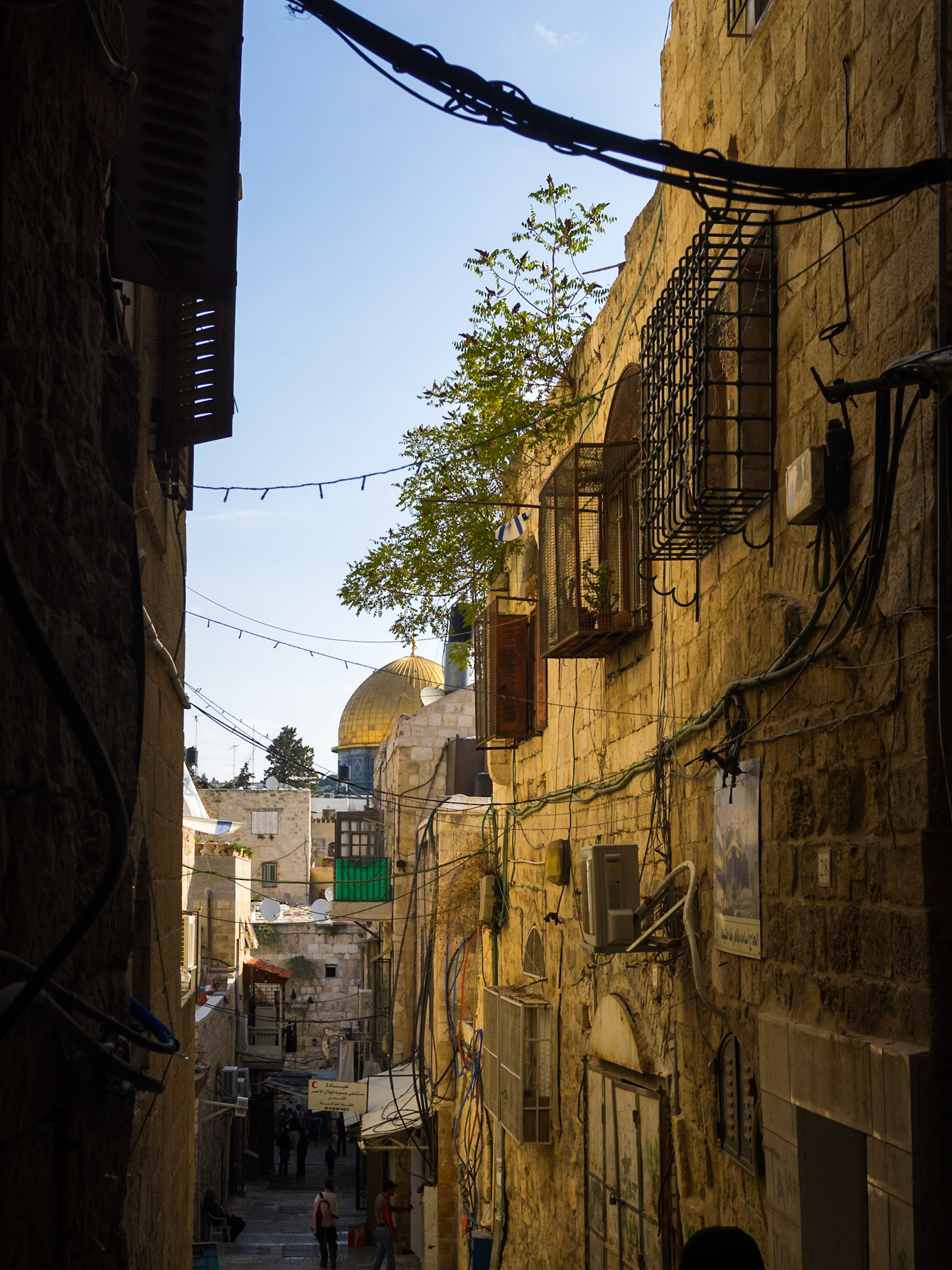 The Dome of the Rock seen at the end of a street from the Muslim Quarter of Old Jerusalem
