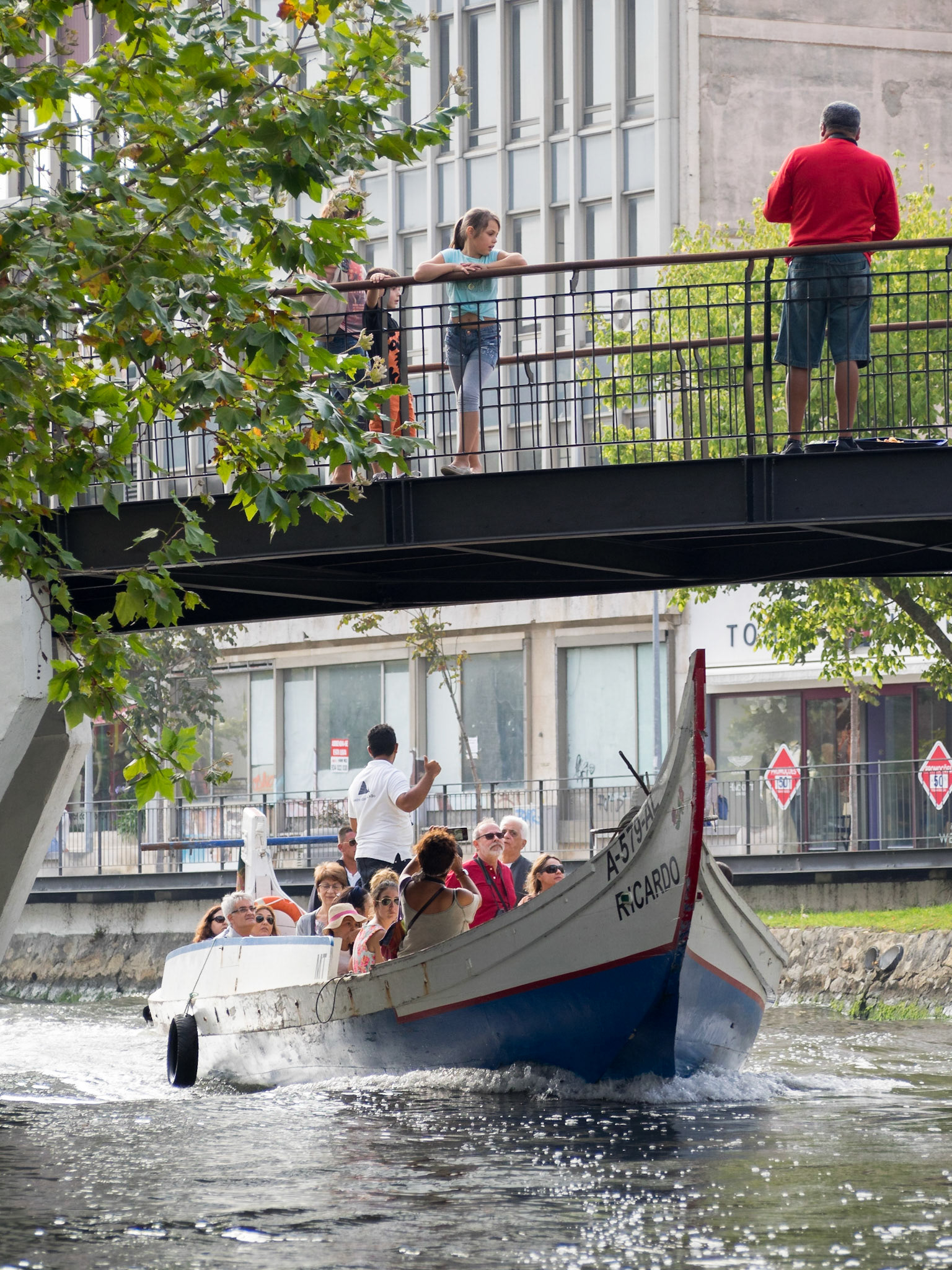 Tourists travelling the Aveiro canals in a typical moliceiro boat