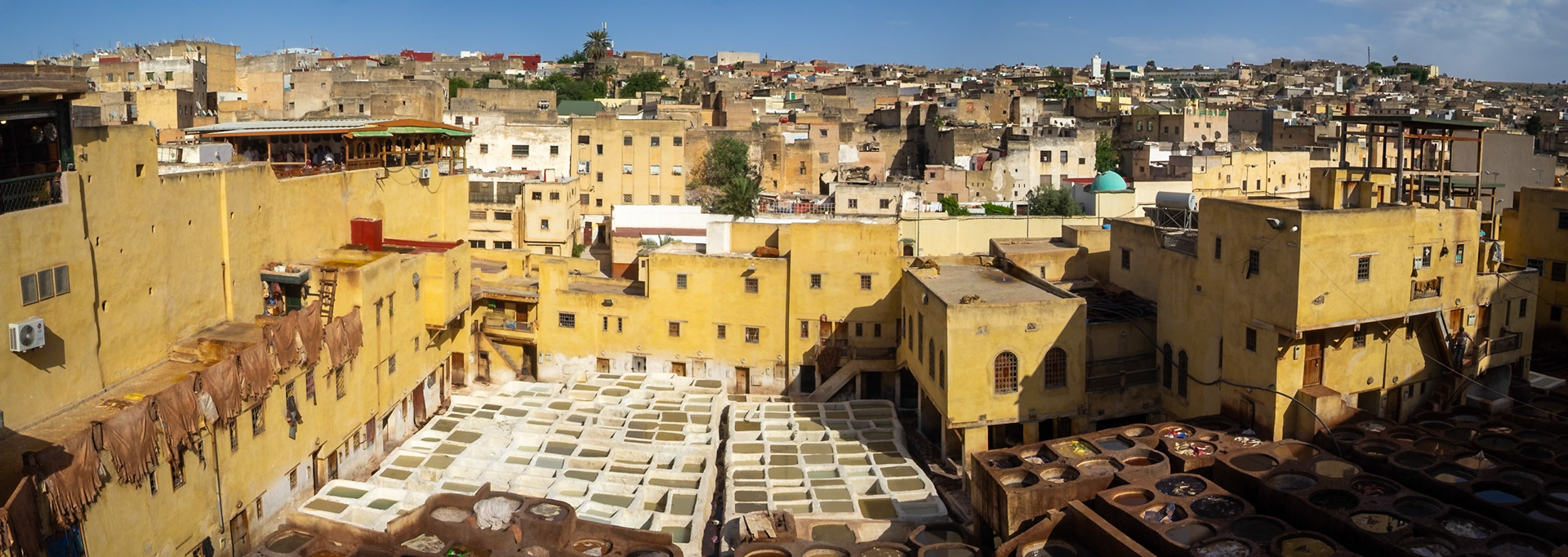 Fez medina tannery tanks between the buildings and the cityscape, Morocco