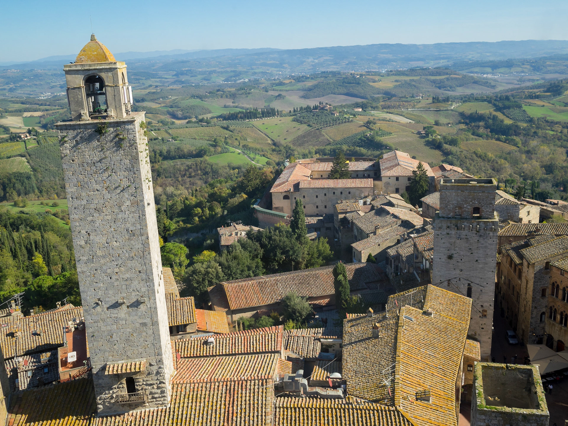 Torre Rognosa over San Gimignano roofs and Tuscany landscape