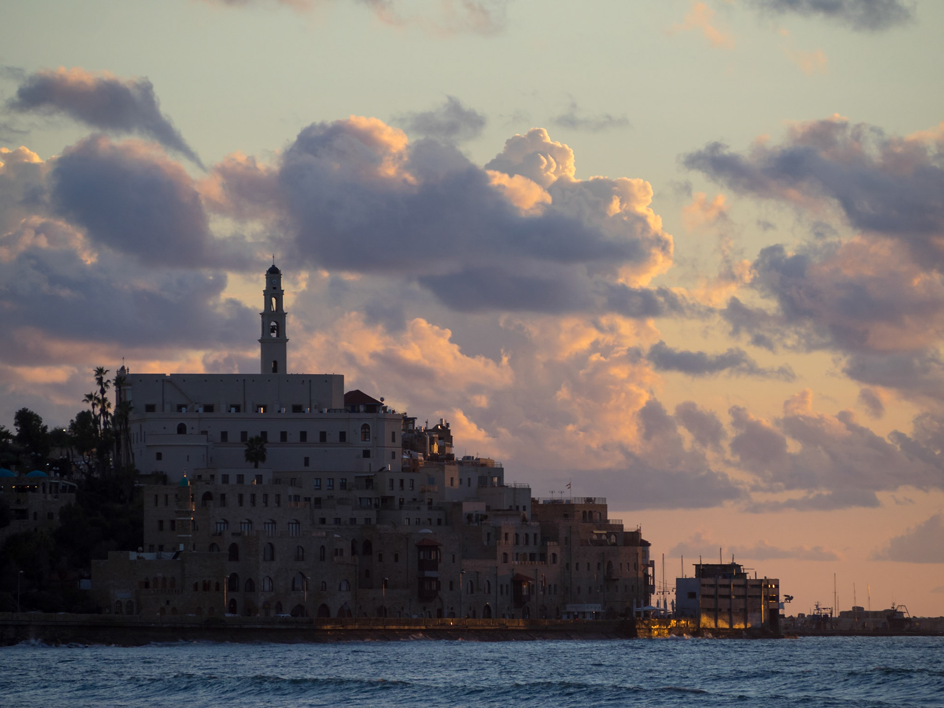Old Jaffa silhouette with pink clouds at end of day