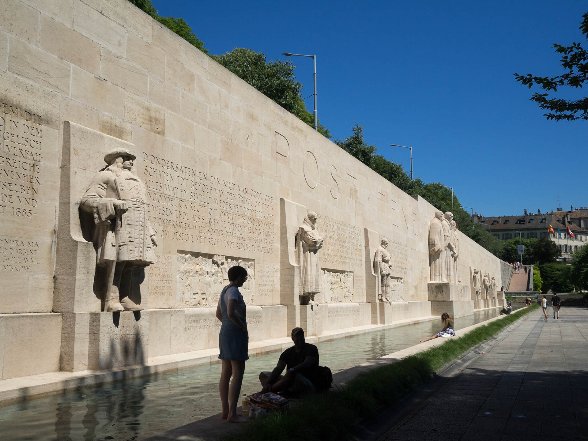 Tourists having a rest by the Reformation Wall, Geneva