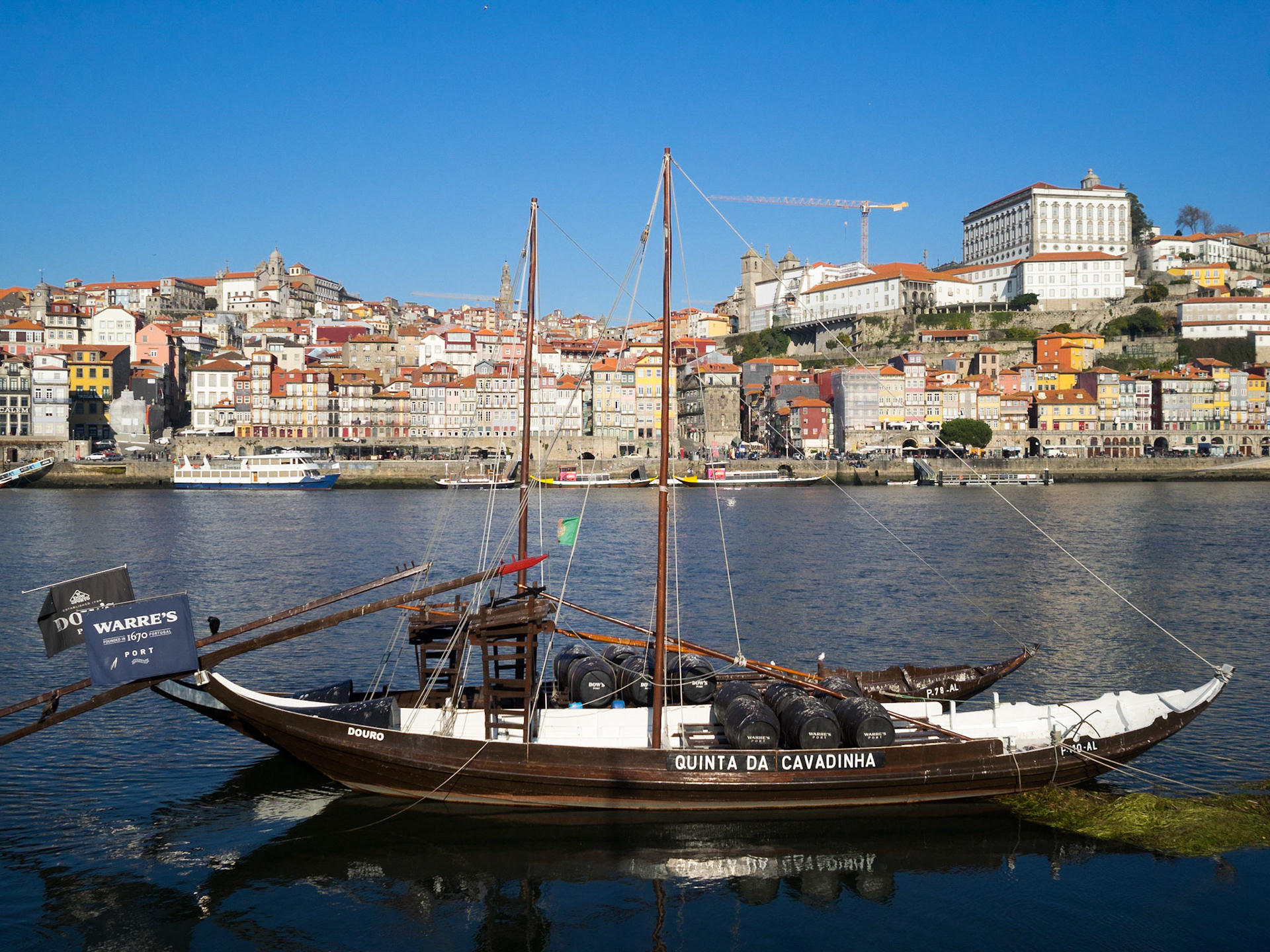 Port Wine transportation boats in Douro River with Oporto city in background