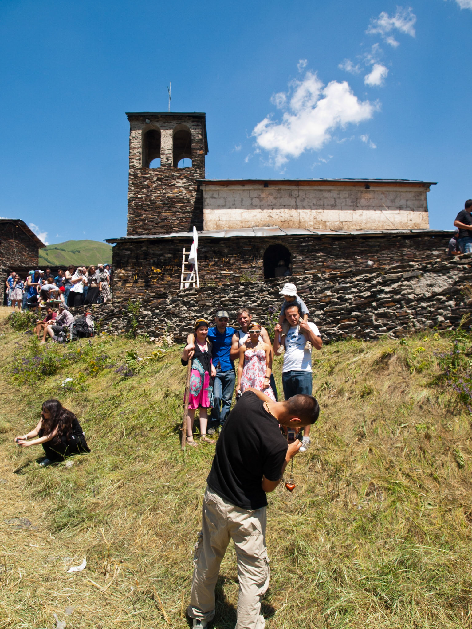 Georgian pilgrims taking pictures in Lamaria Church, Svaneti, Georgia