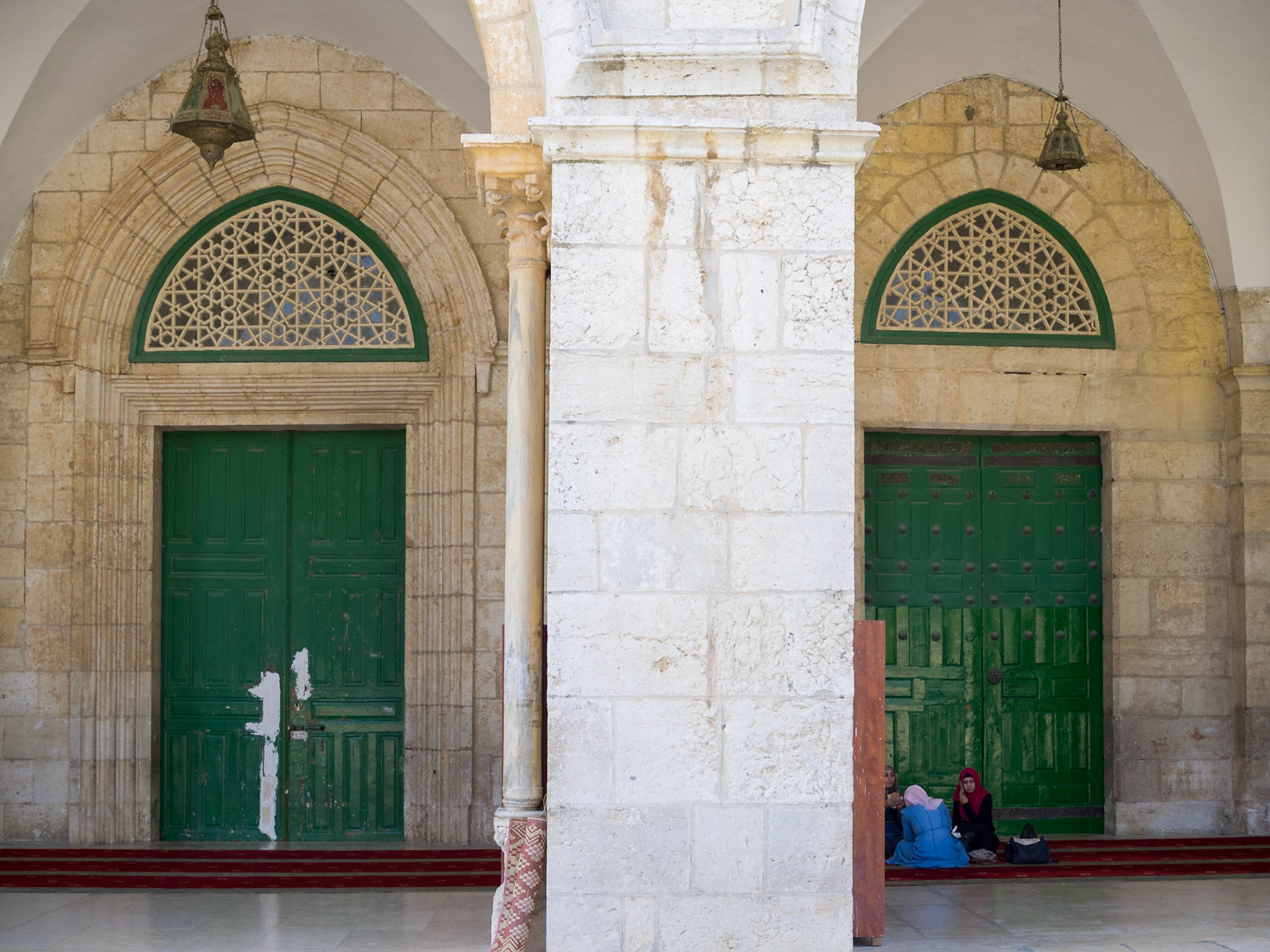Muslim women talking under the archways of Al-Aqsa Mosque